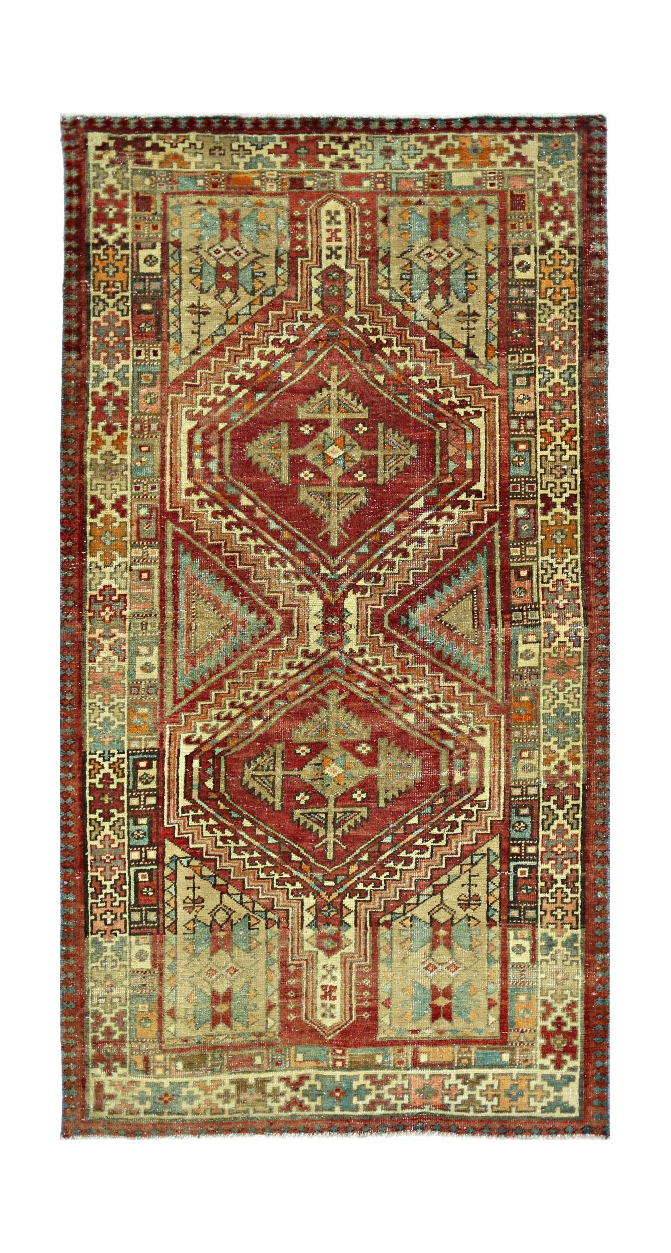 A handmade vintage Persian rug featuring two large geometric medallions in red and blue tones.