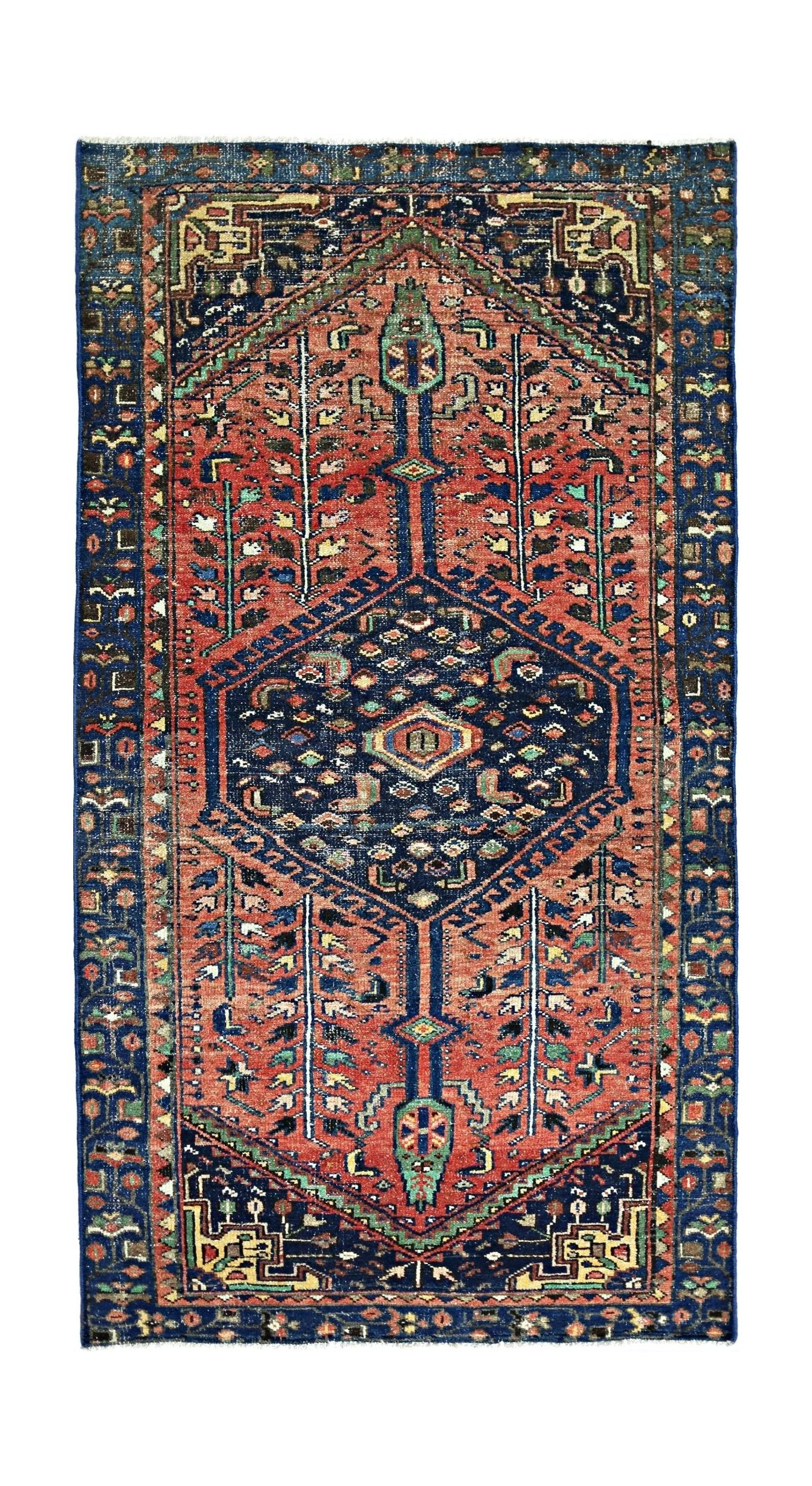 A vintage handmade Persian Hamadan rug featuring a central medallion on a red and blue field.