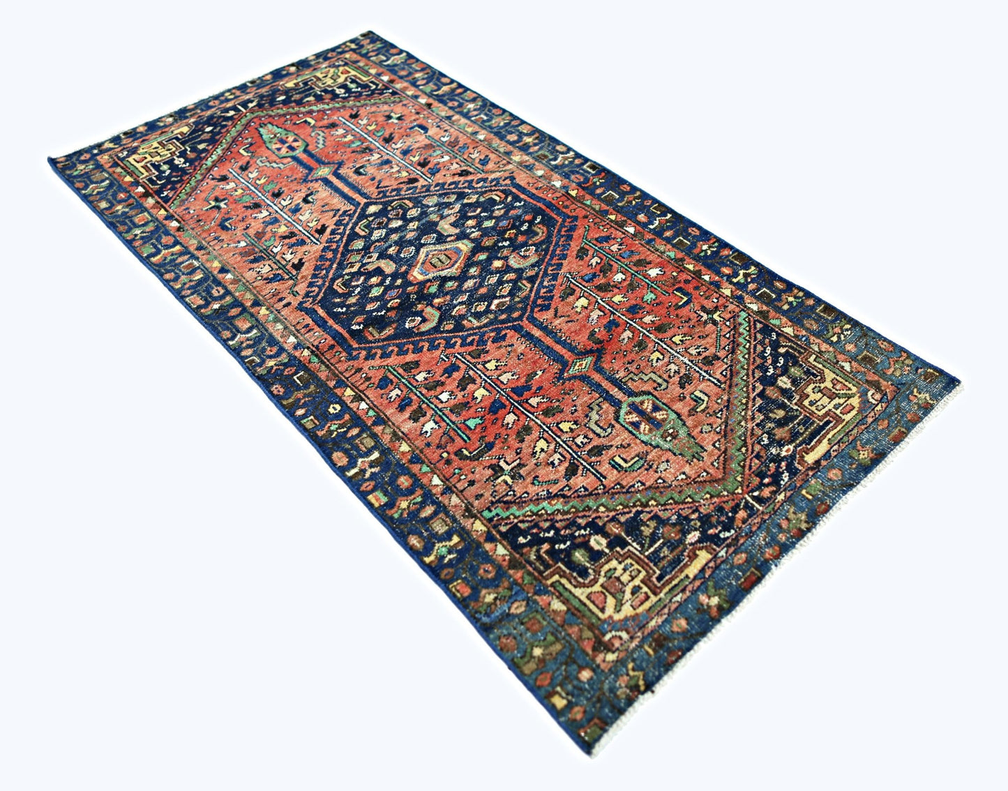 A vintage handmade Persian Hamadan rug featuring a geometric medallion pattern in red and blue.