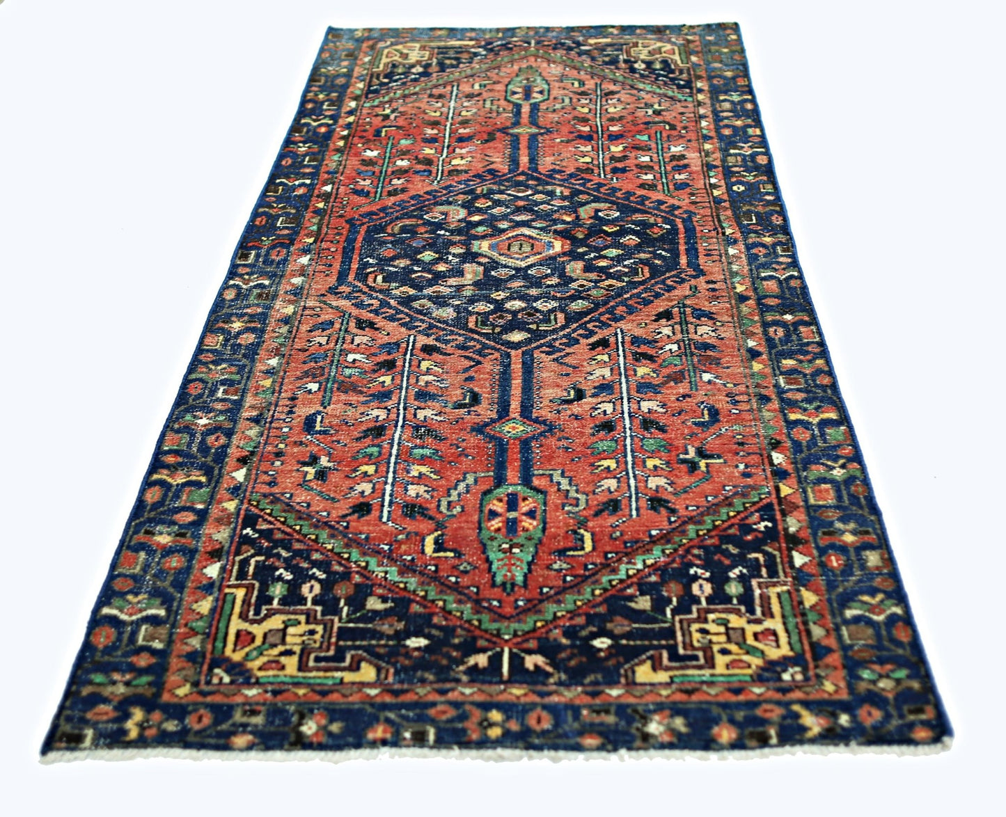 A vintage handmade Persian Hamadan rug featuring a geometric medallion on a red field.