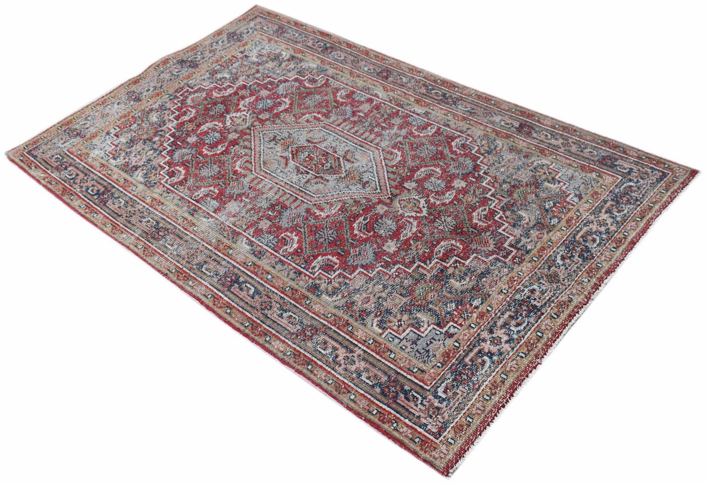 A rectangular vintage Persian rug featuring a central medallion in shades of red, blue, and cream.