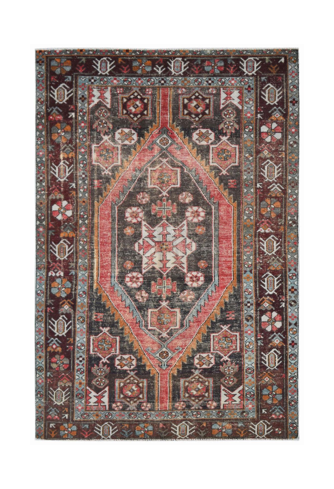 A vintage Persian Hamadan rug featuring a central diamond medallion in red, black, and blue tones.
