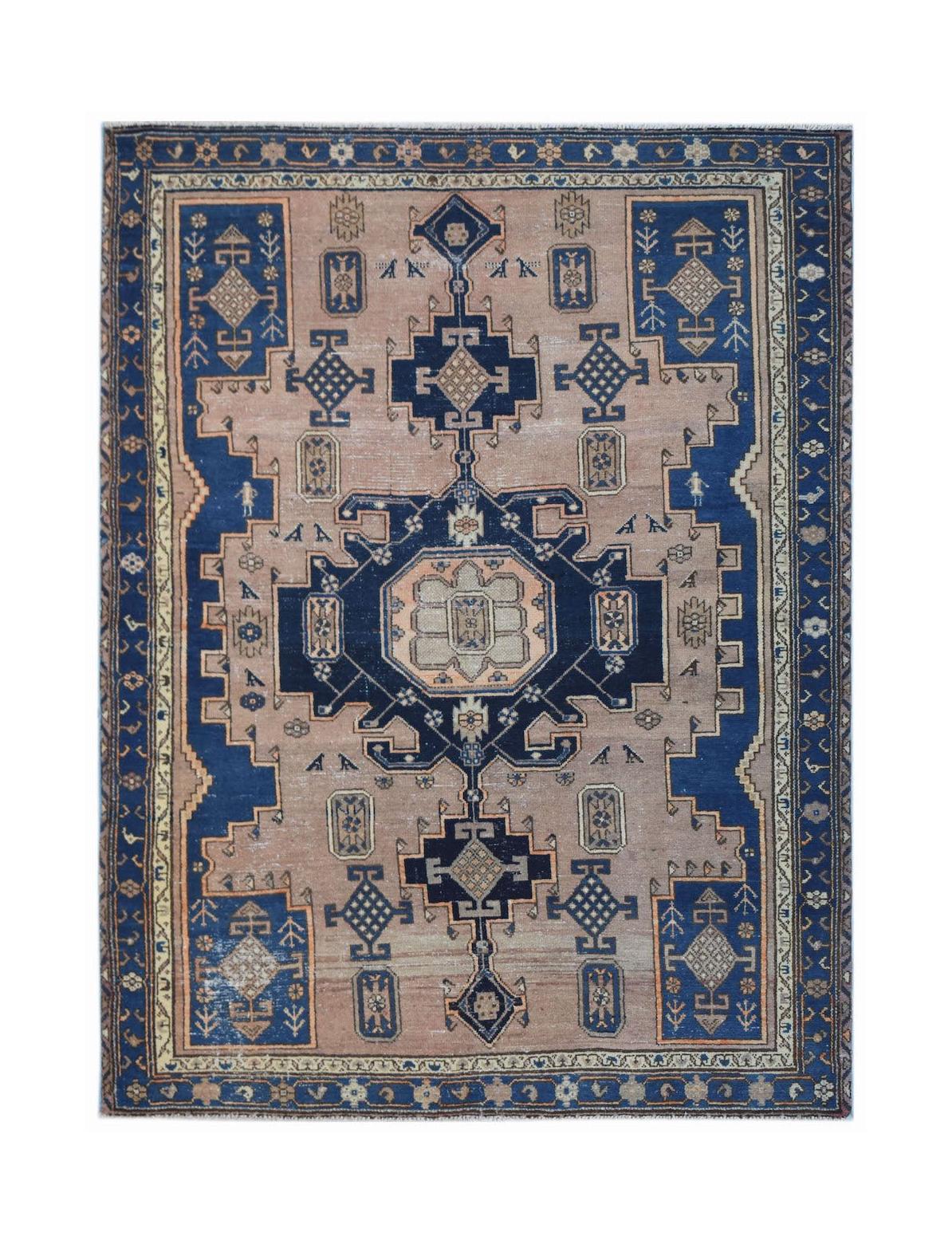 Handwoven vintage Persian rug featuring a central blue medallion on a light brown field.