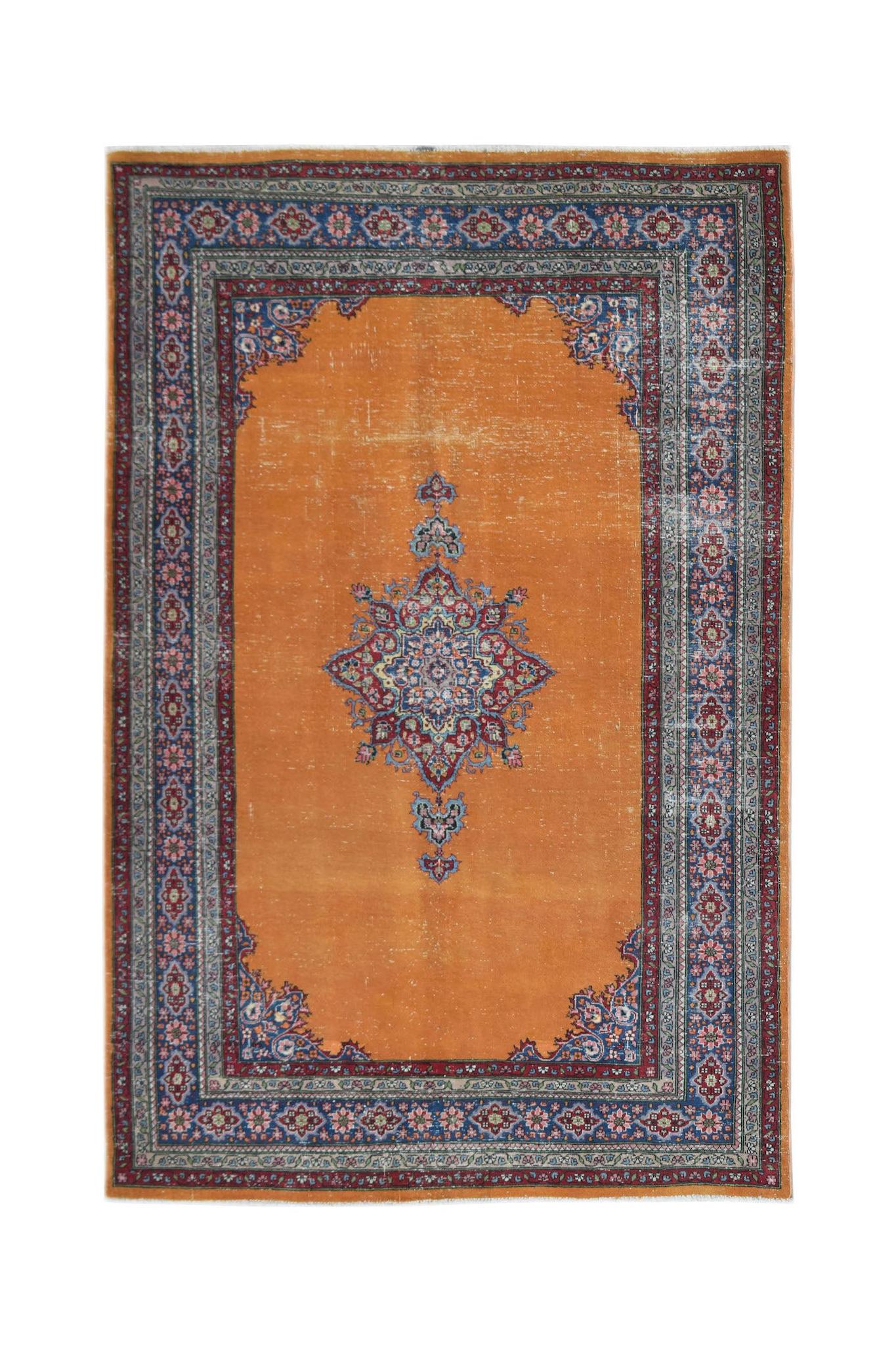 Vintage Persian Mashad rug featuring a central floral medallion on a bright orange field.