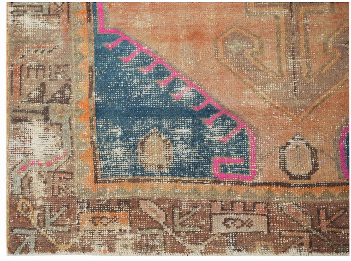 A vintage handwoven Persian rug featuring geometric patterns in orange, blue, and brown tones.