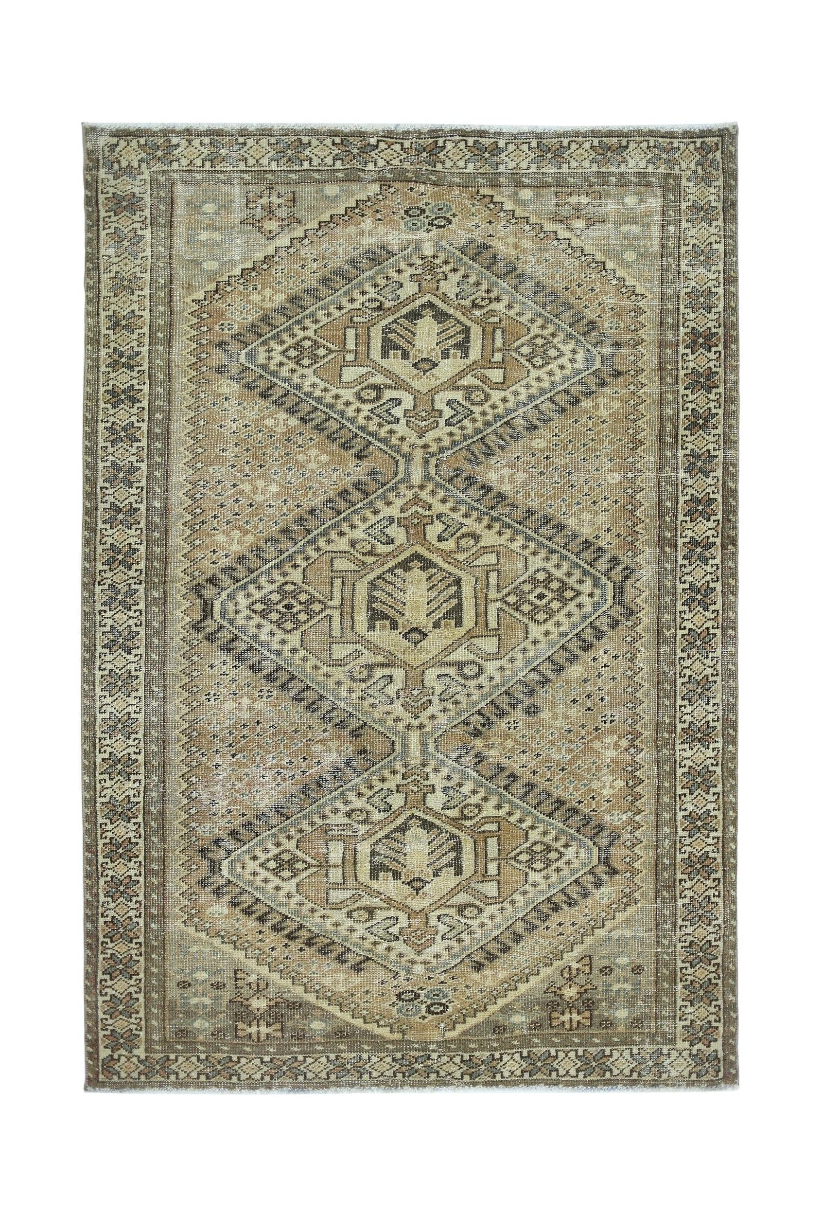 Vintage Persian Qashqai rug featuring a geometric diamond pattern in neutral earth tones.