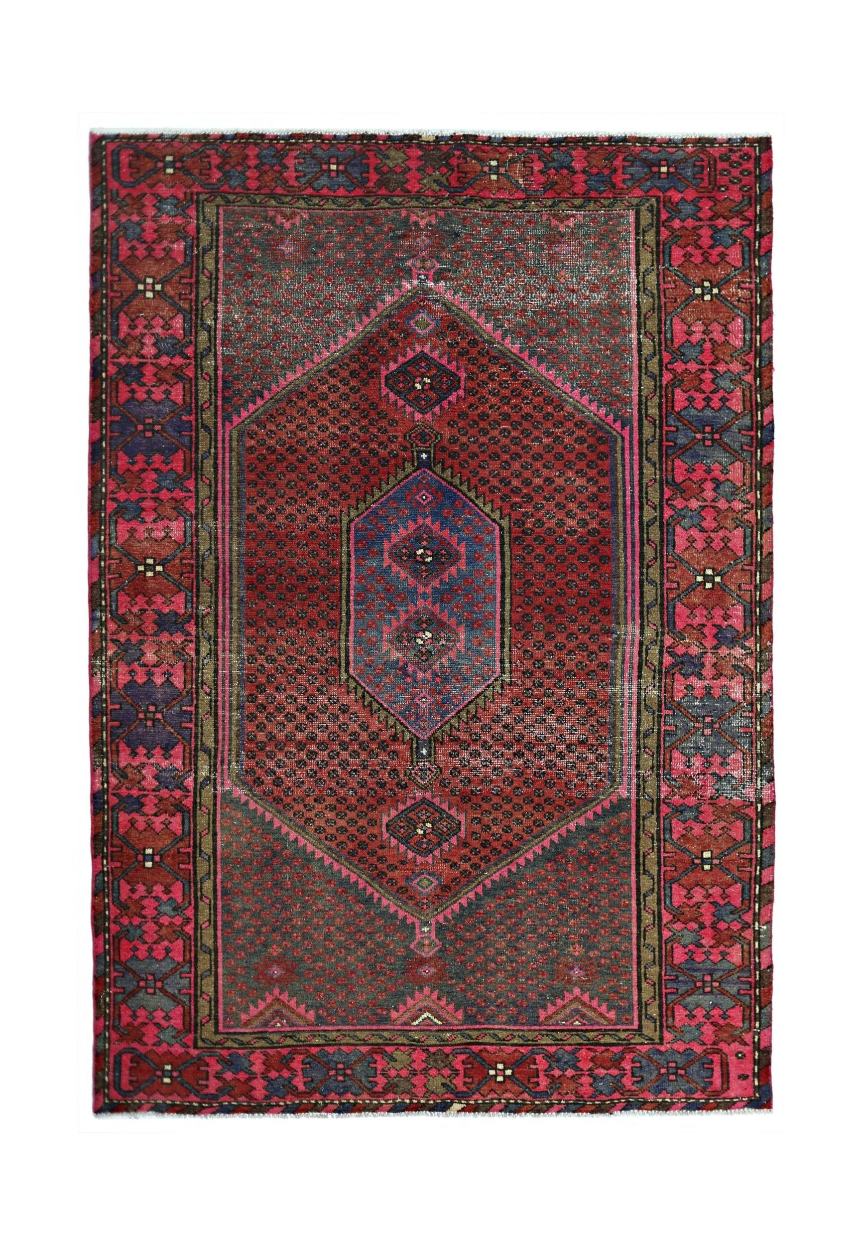 A vintage handmade Persian Hamadan rug featuring a central blue medallion on a red patterned field.