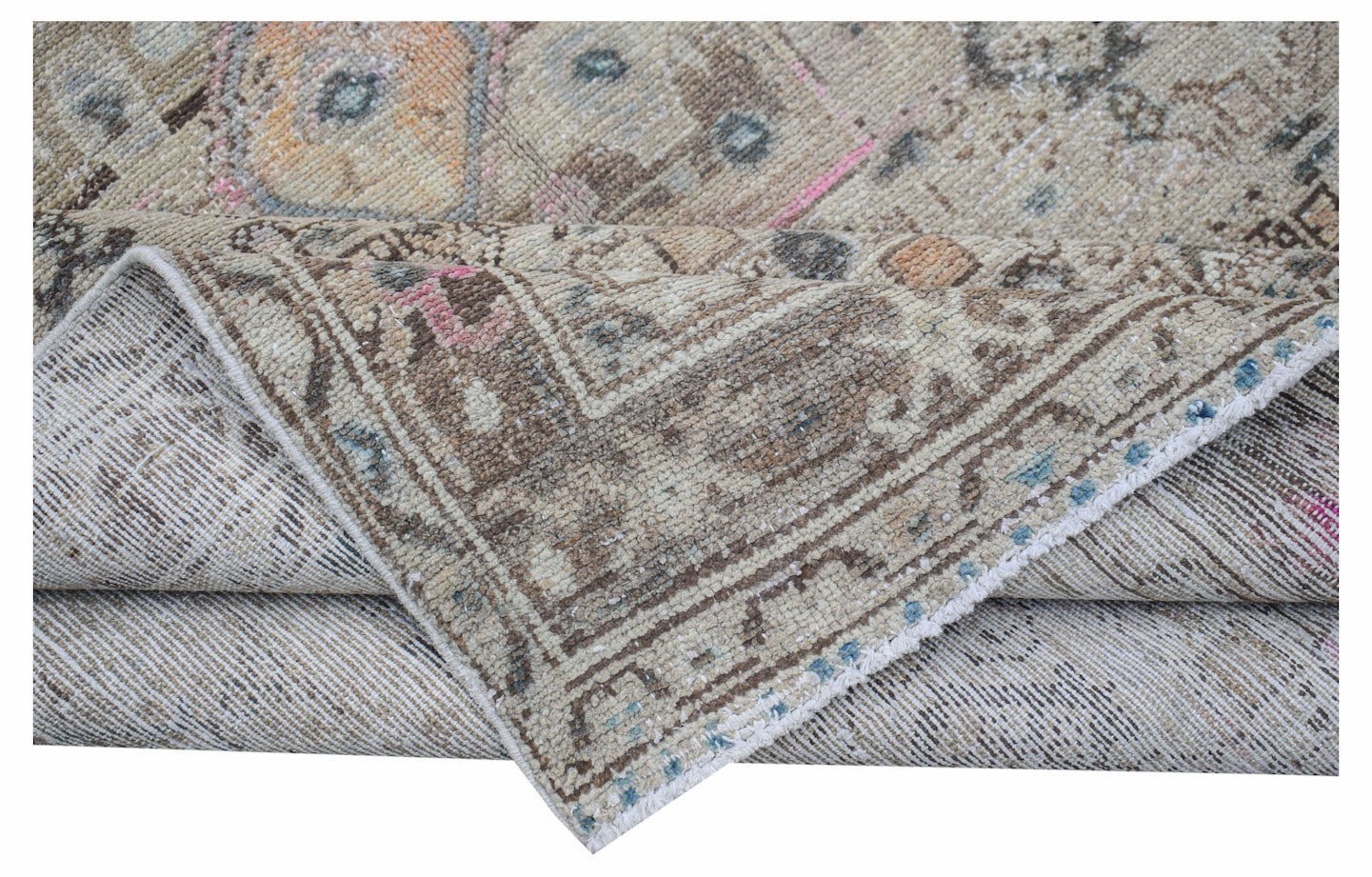 Vintage Persian rug with a distressed pattern in neutral tones.
