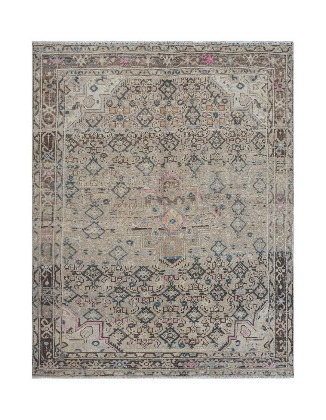 Vintage Persian rug with a geometric pattern in muted tones.