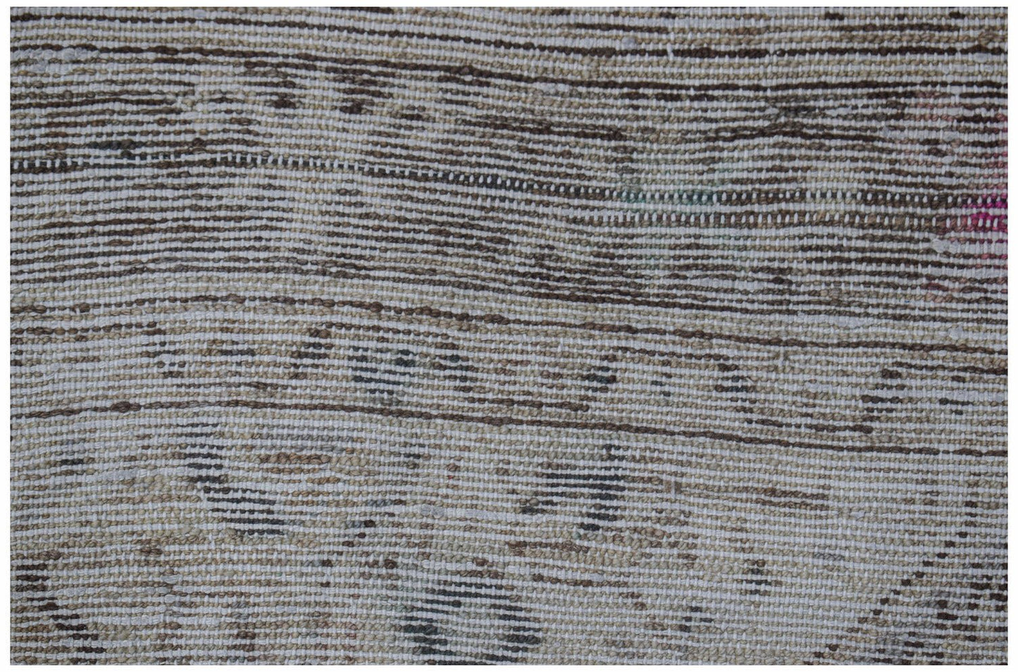A close-up view of a handwoven vintage Persian rug featuring a faded, distressed pattern.