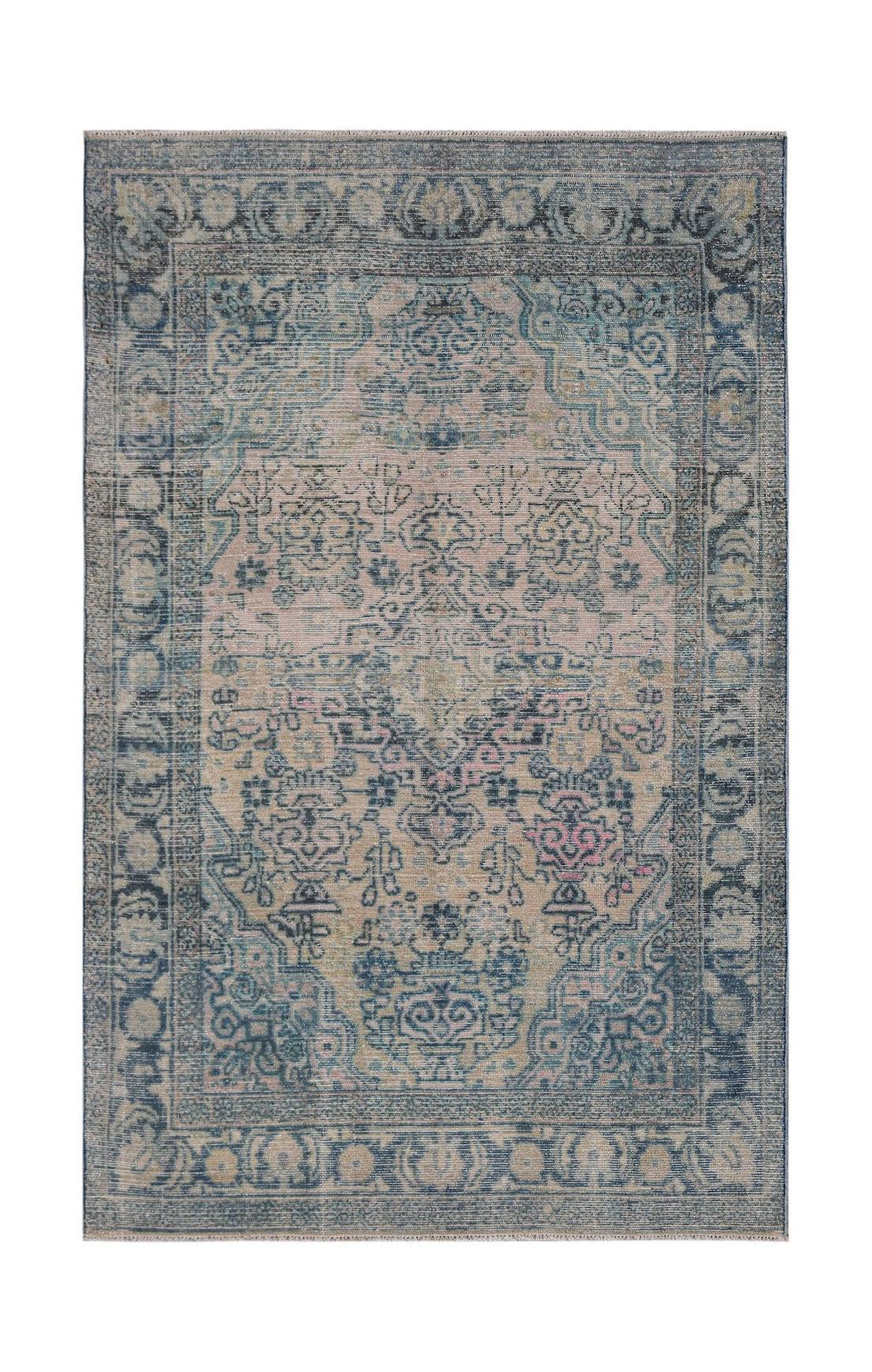Vintage Persian rug with intricate blue and pink floral patterns.