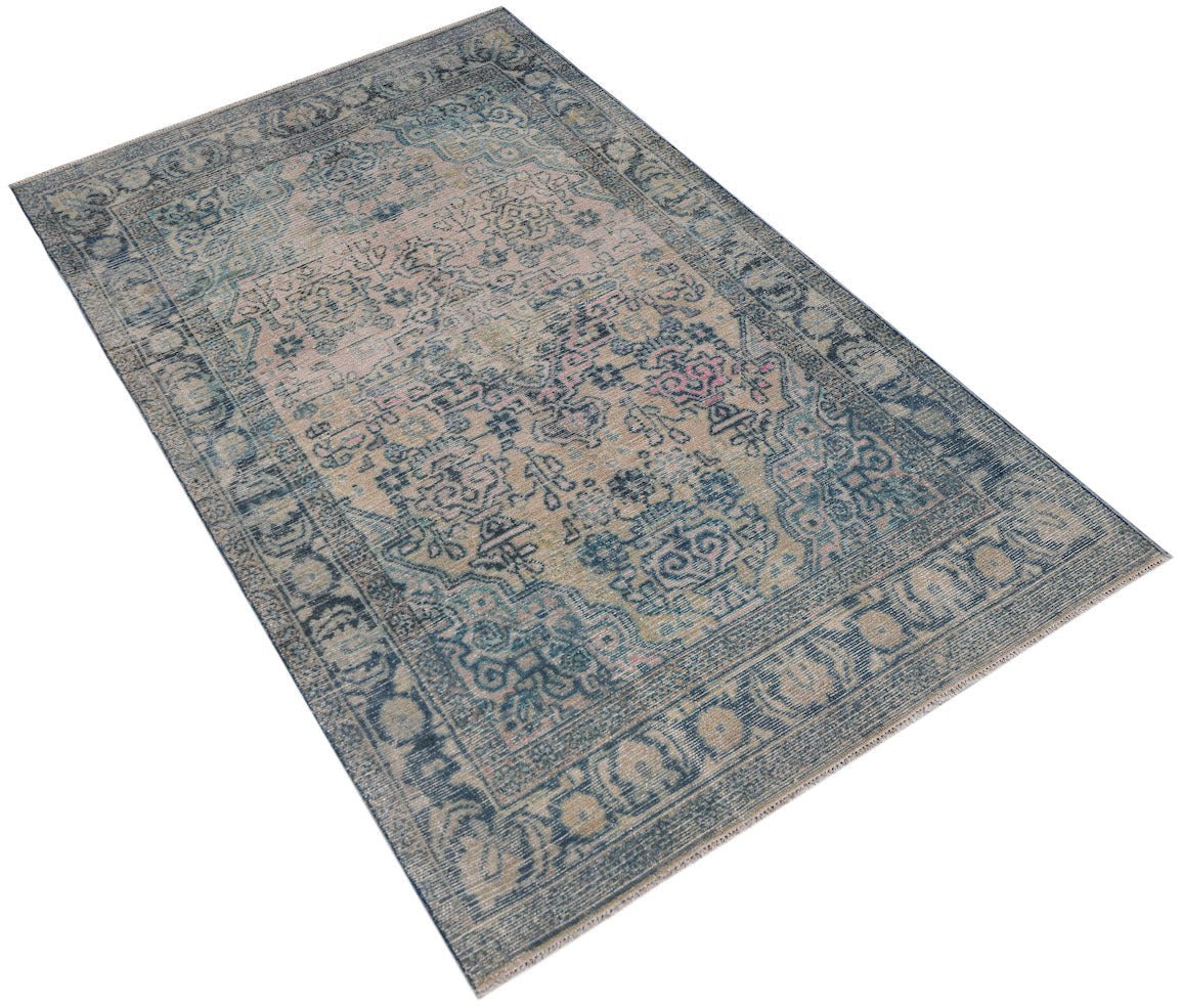 Vintage Persian rug with a distressed blue and beige floral pattern.