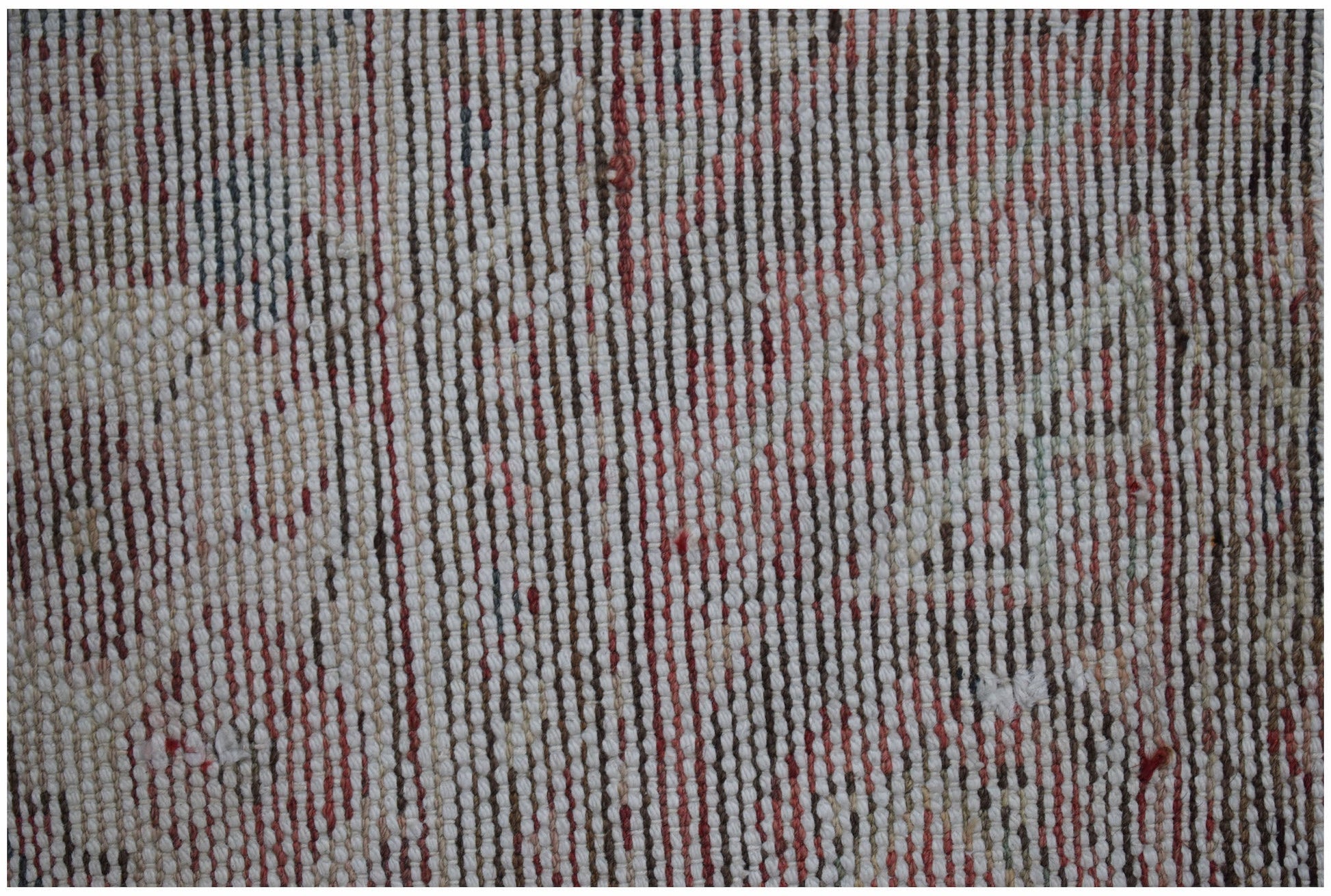 A close-up view of a vintage Persian rug featuring a textured, handwoven pattern in faded tones.