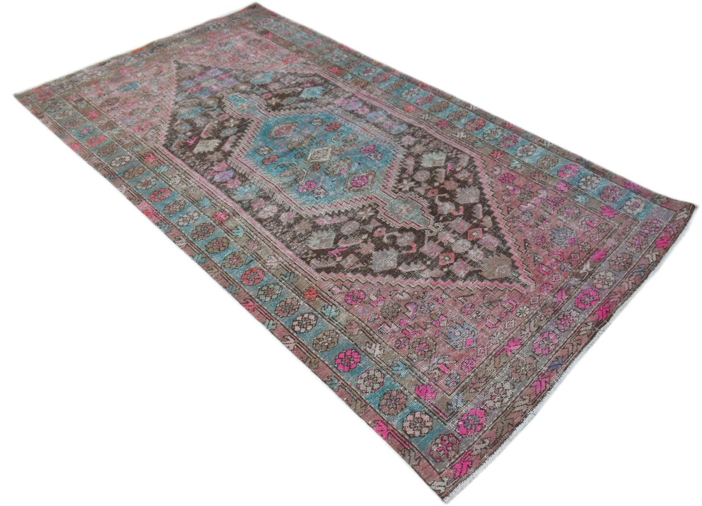 A vintage Persian Hamadan rug featuring a central medallion in shades of brown, pink, and blue.