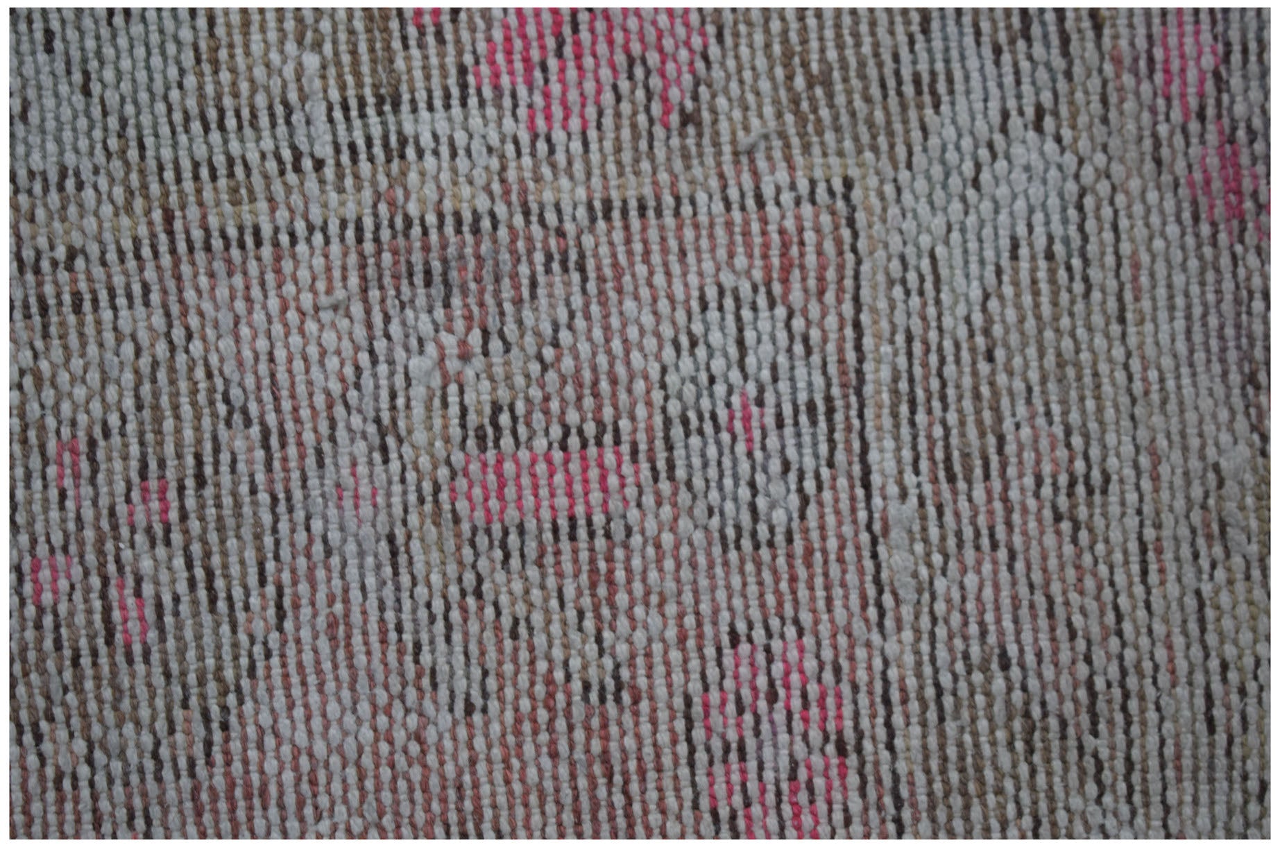 A close-up view of a vintage Persian Hamadan rug featuring faded floral patterns in wool.