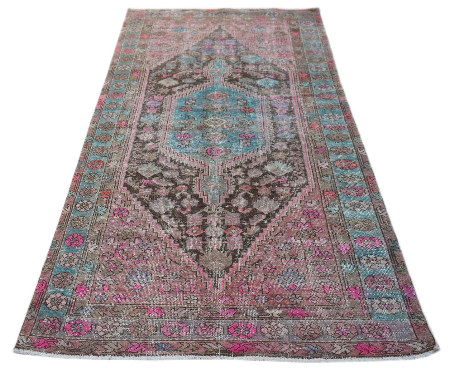 A vintage handwoven Persian Hamadan rug featuring a central medallion in pink, brown, and blue.