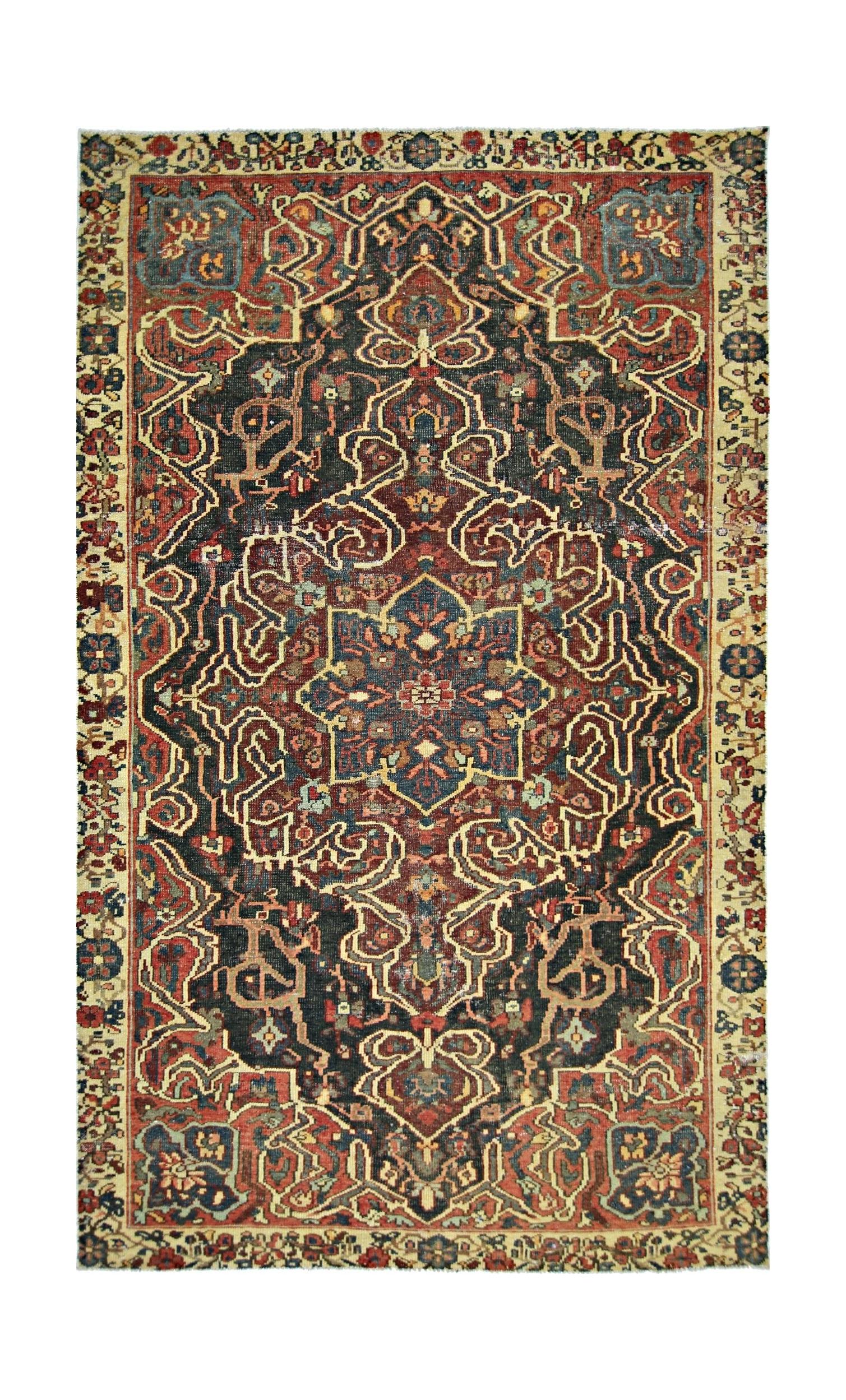 A vintage handmade Persian rug featuring a central floral medallion on a dark patterned field.