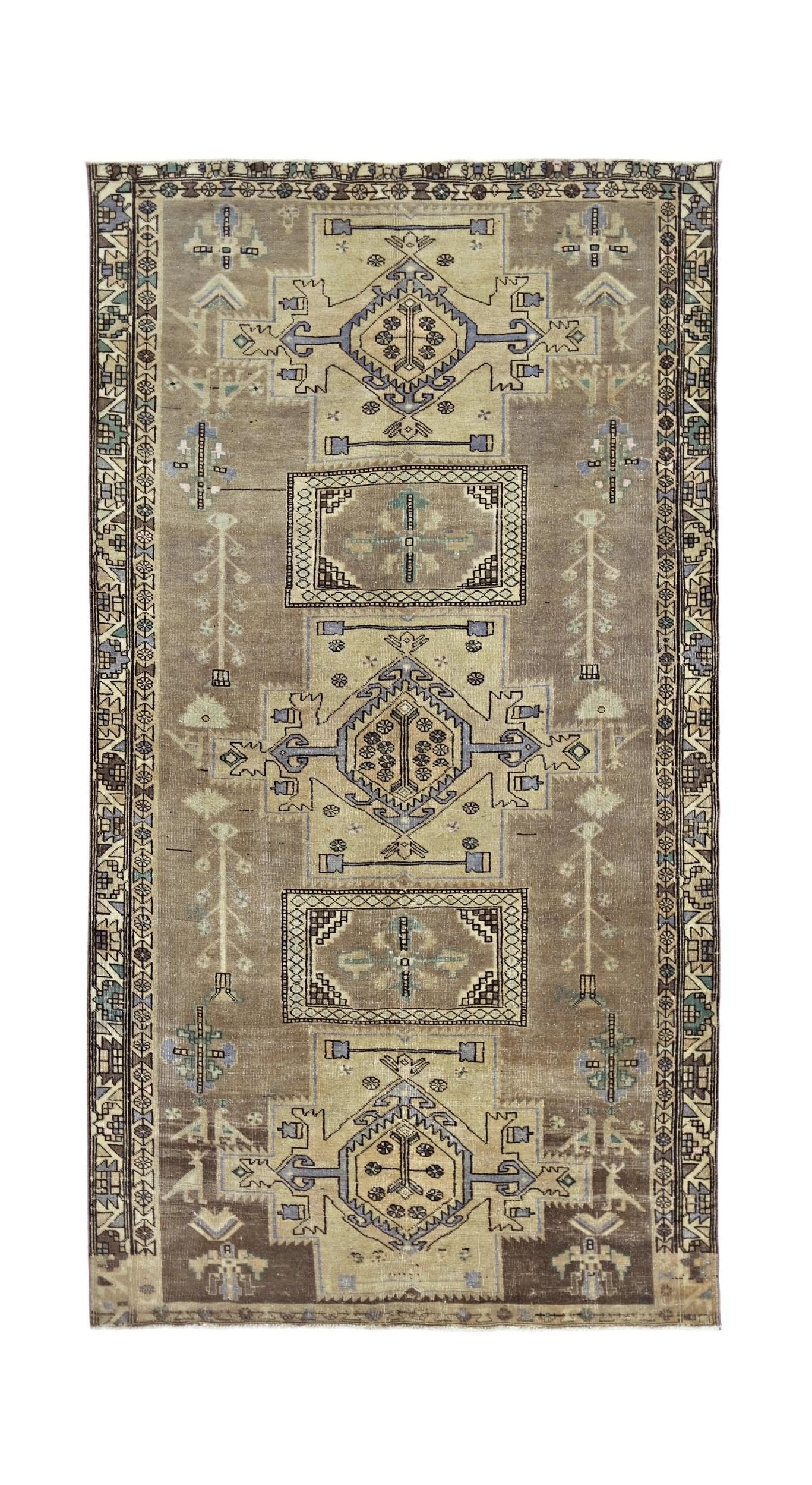 Vintage Persian rug with geometric patterns in brown, beige, and blue.