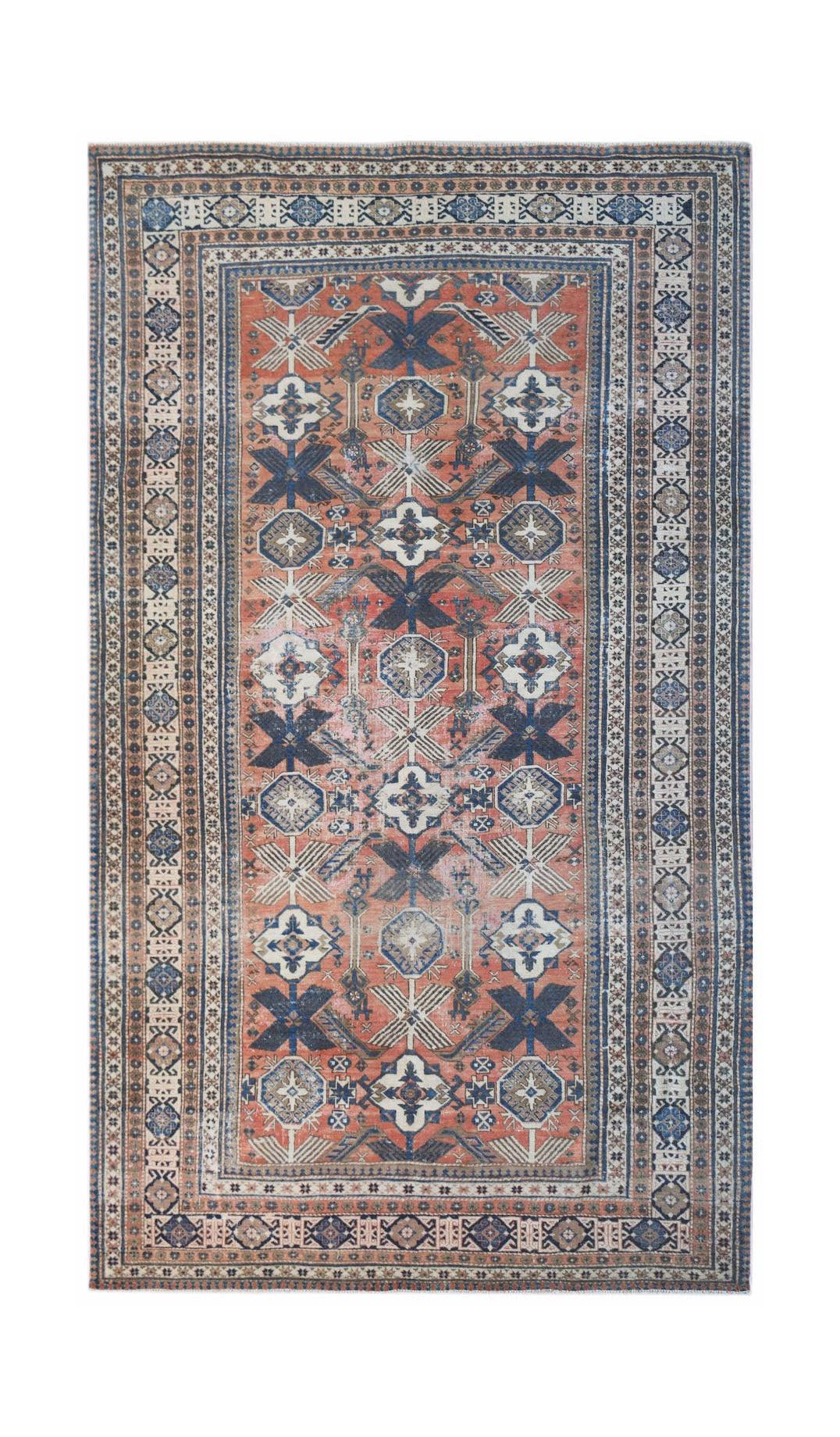 A vintage handwoven Persian rug featuring a geometric pattern in shades of red, blue, and cream.