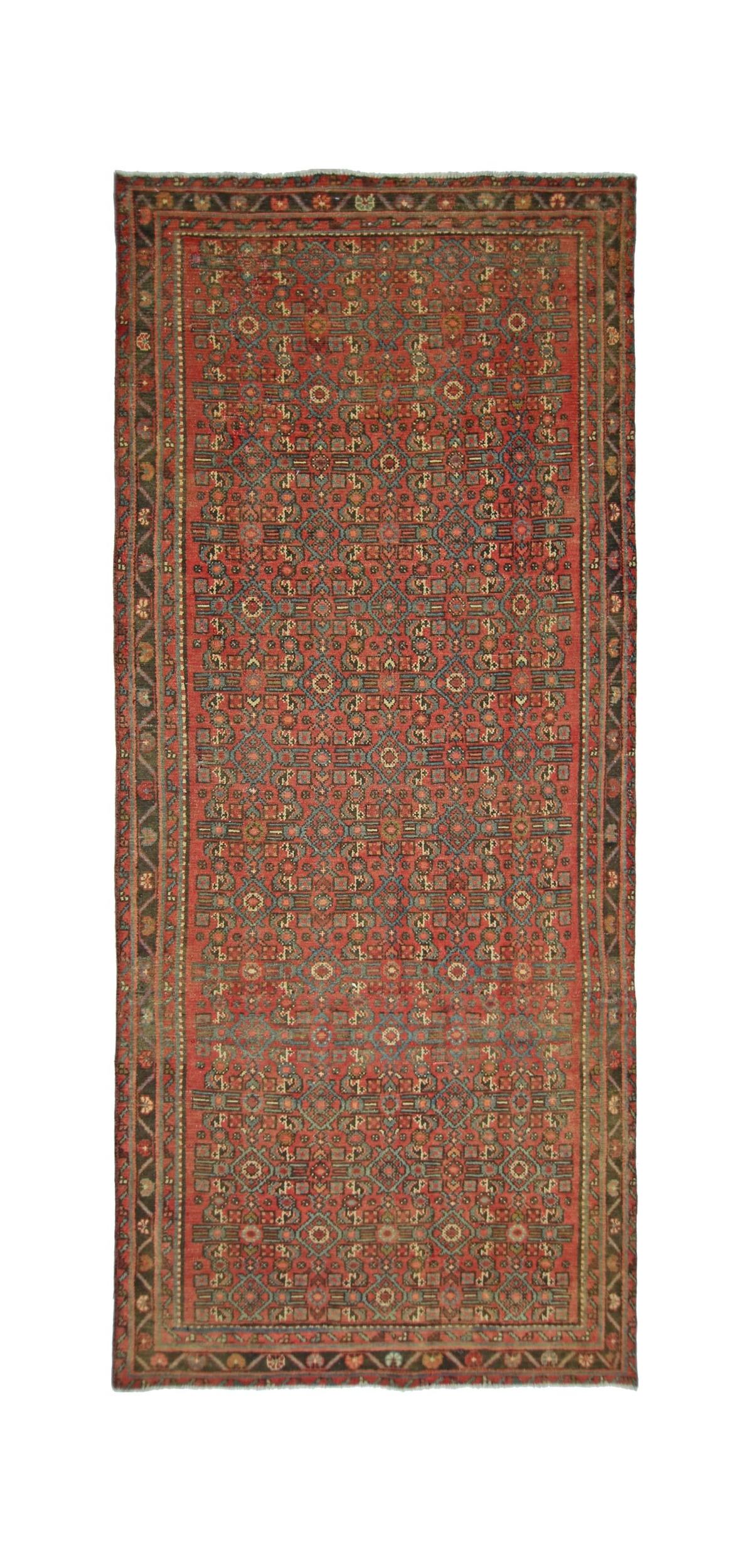 A rectangular vintage Persian rug featuring a geometric pattern in red, blue, and tan tones.