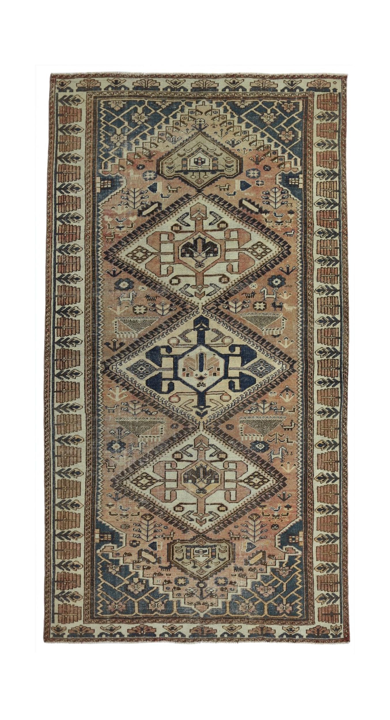 A handmade vintage Persian rug featuring a geometric diamond pattern in muted earth tones.