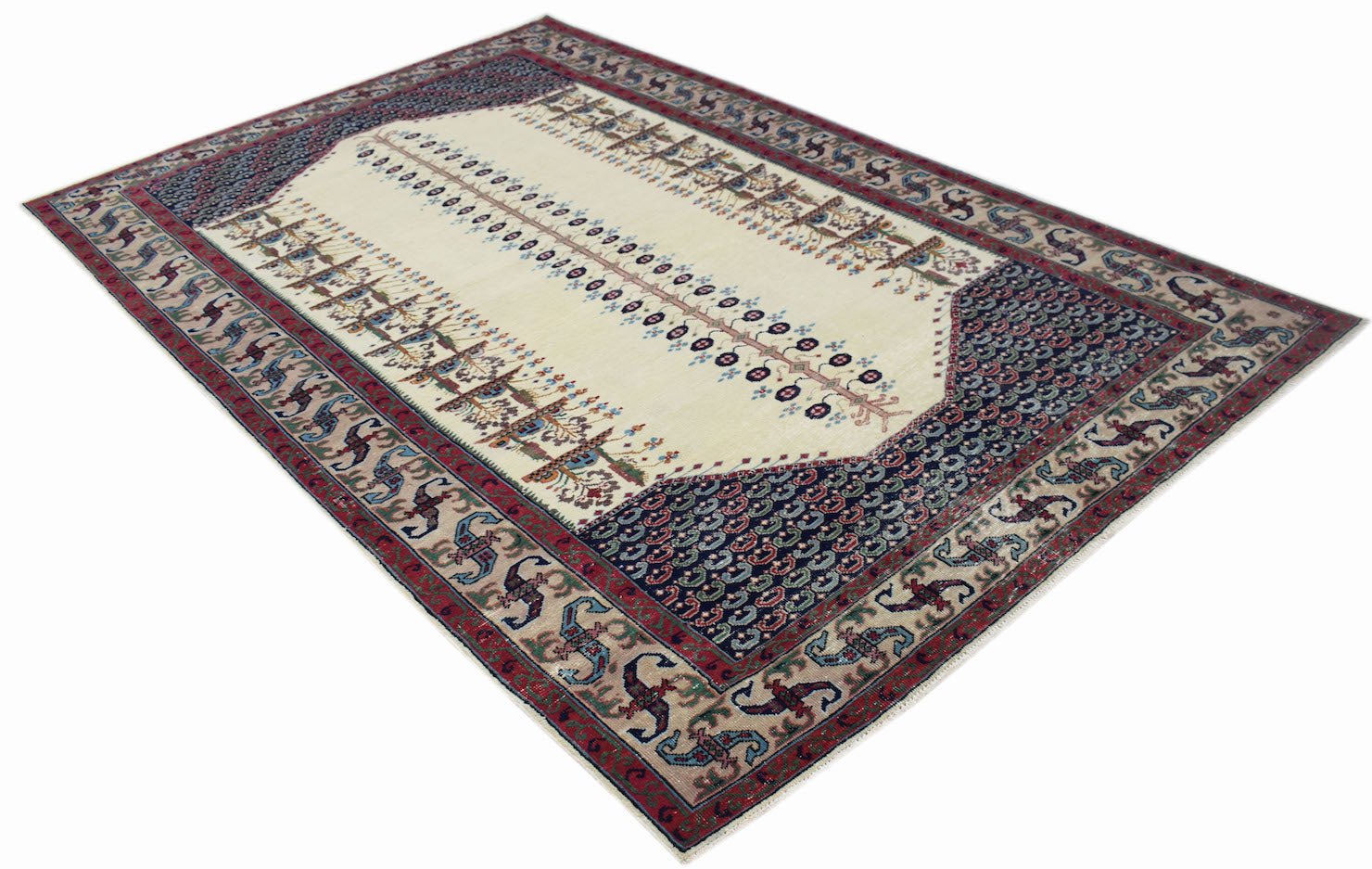 A handwoven vintage Persian rug featuring a cream central field with floral motifs and dark borders.