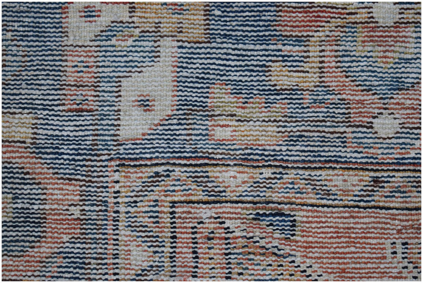 A close-up view of a handwoven vintage Persian rug featuring intricate geometric patterns.