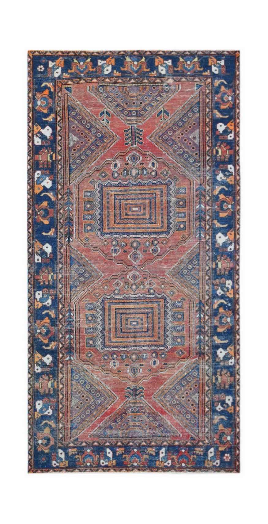 A handwoven vintage Persian rug featuring geometric patterns in shades of red and blue.
