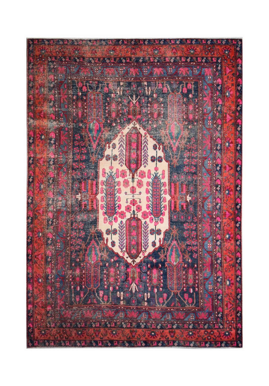 A handwoven vintage Persian rug featuring a central cream medallion on a dark blue and red field.