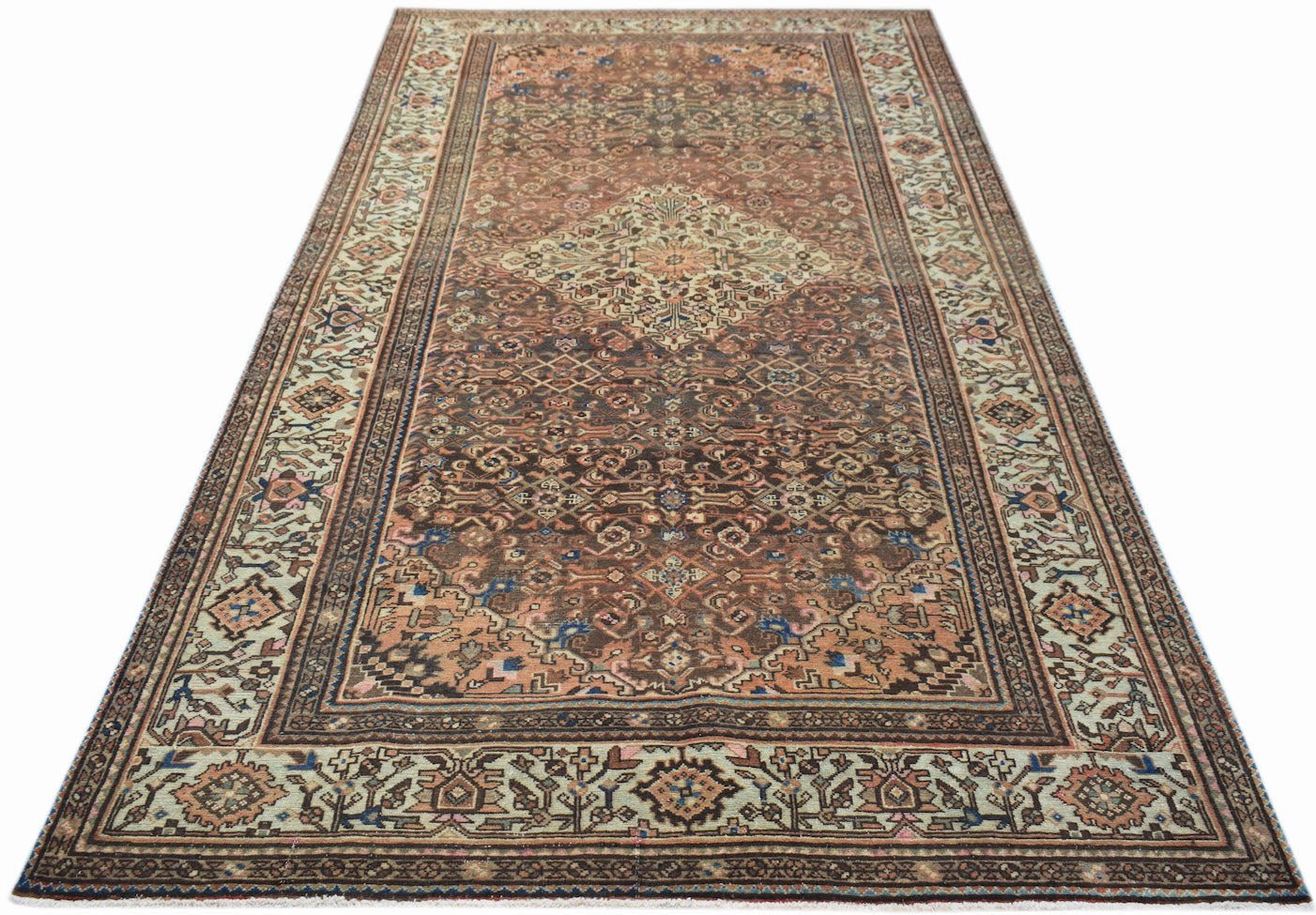 A handwoven vintage Persian rug featuring a central medallion and intricate floral patterns.