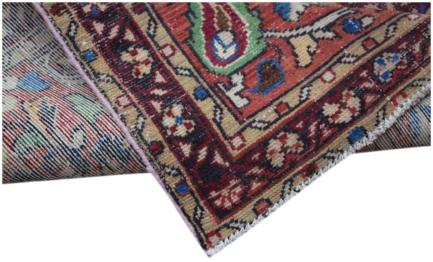 A vintage Persian Sarouk runner featuring a floral pattern with a worn, abrash-dyed wool texture.