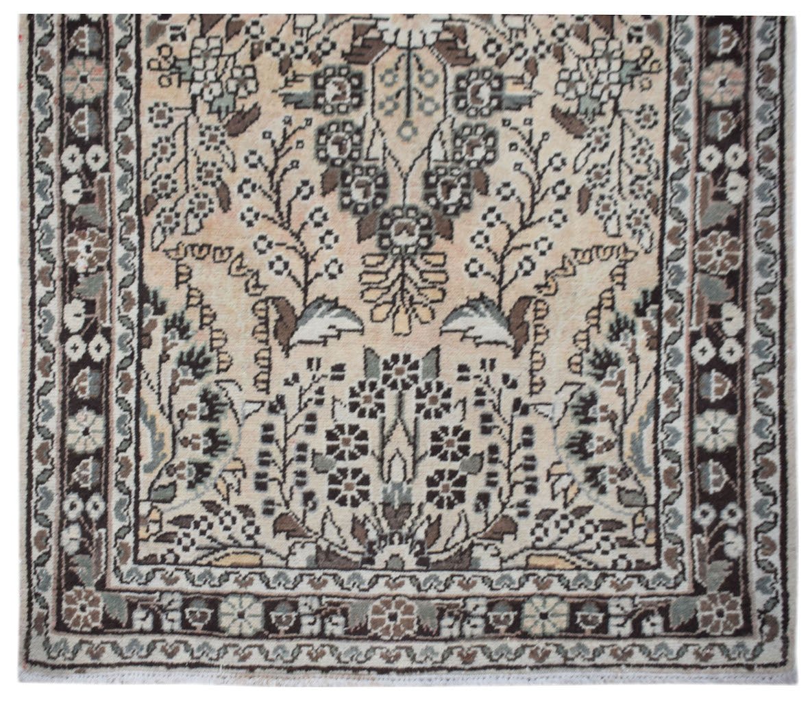 A vintage Persian Sarouk runner featuring a floral pattern in muted brown and cream tones.
