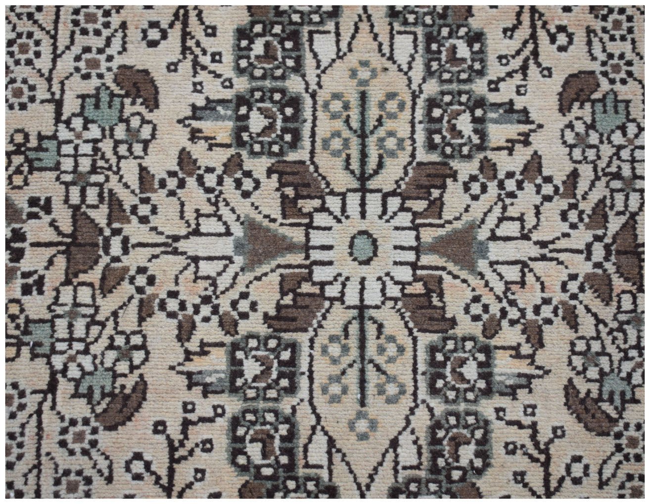 A vintage Persian Sarouk runner featuring a symmetrical floral pattern in cream, brown, and blue.