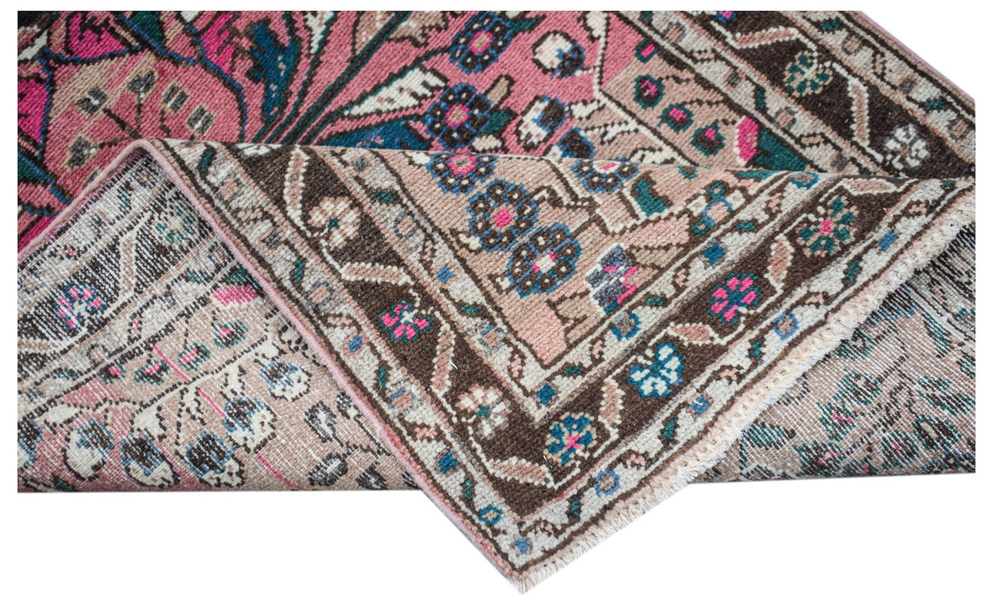 A vintage Persian Sarouk rug with a floral pattern in pink, blue, and brown tones.