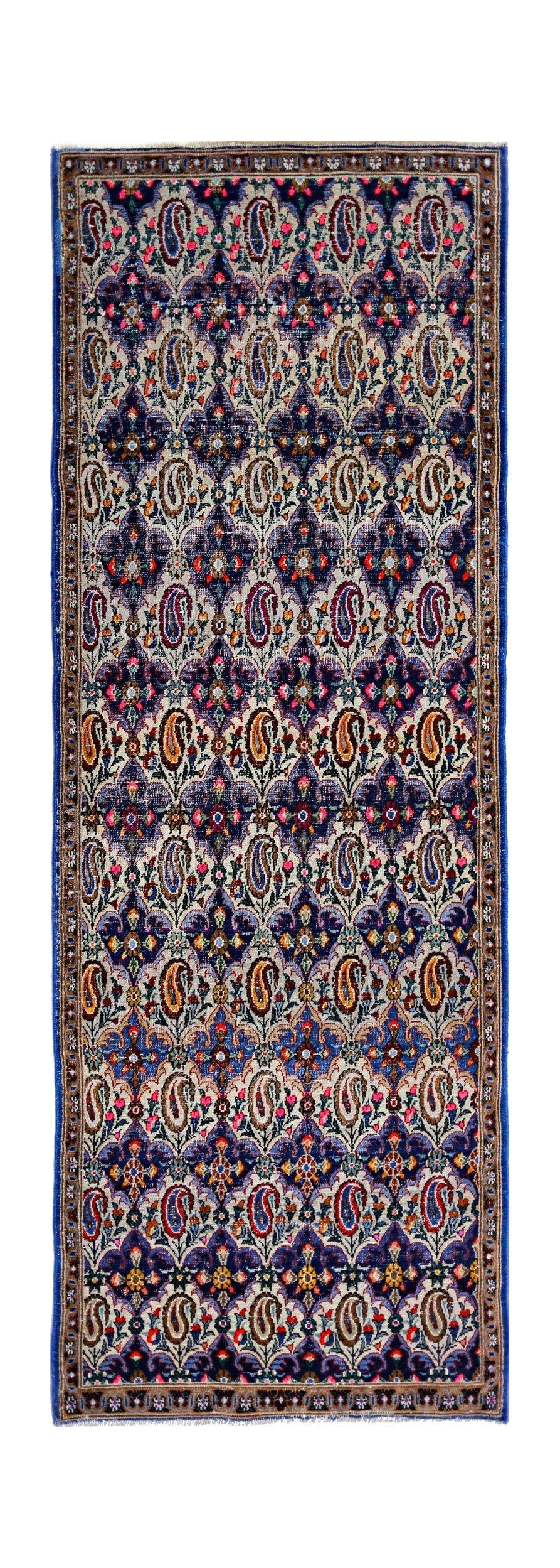 A vintage Persian Senneh runner featuring a repeating paisley pattern in vibrant blue and cream tones.
