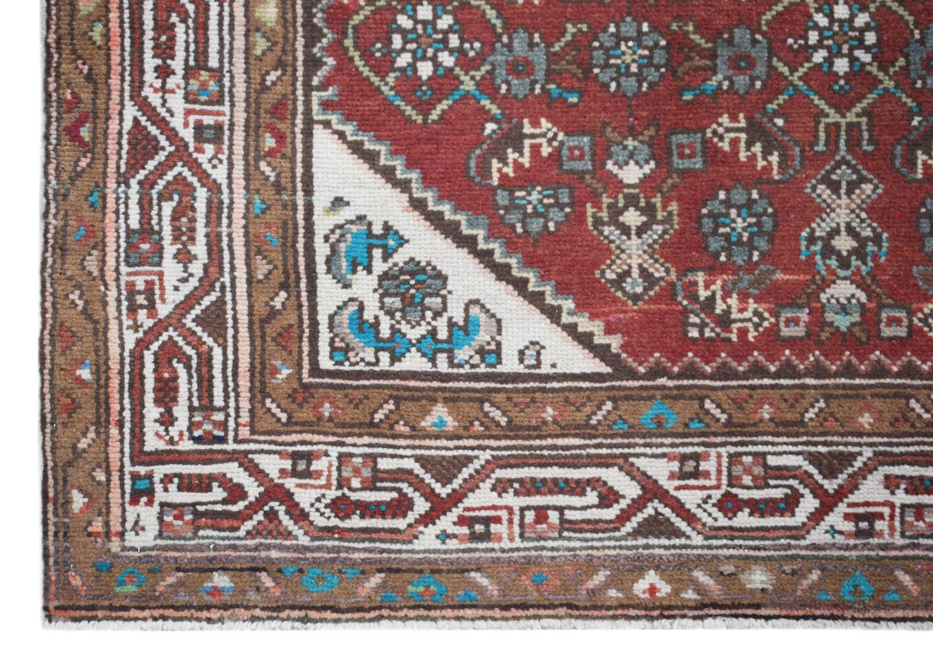 A vintage Persian Senneh runner featuring a red field with intricate geometric floral patterns.