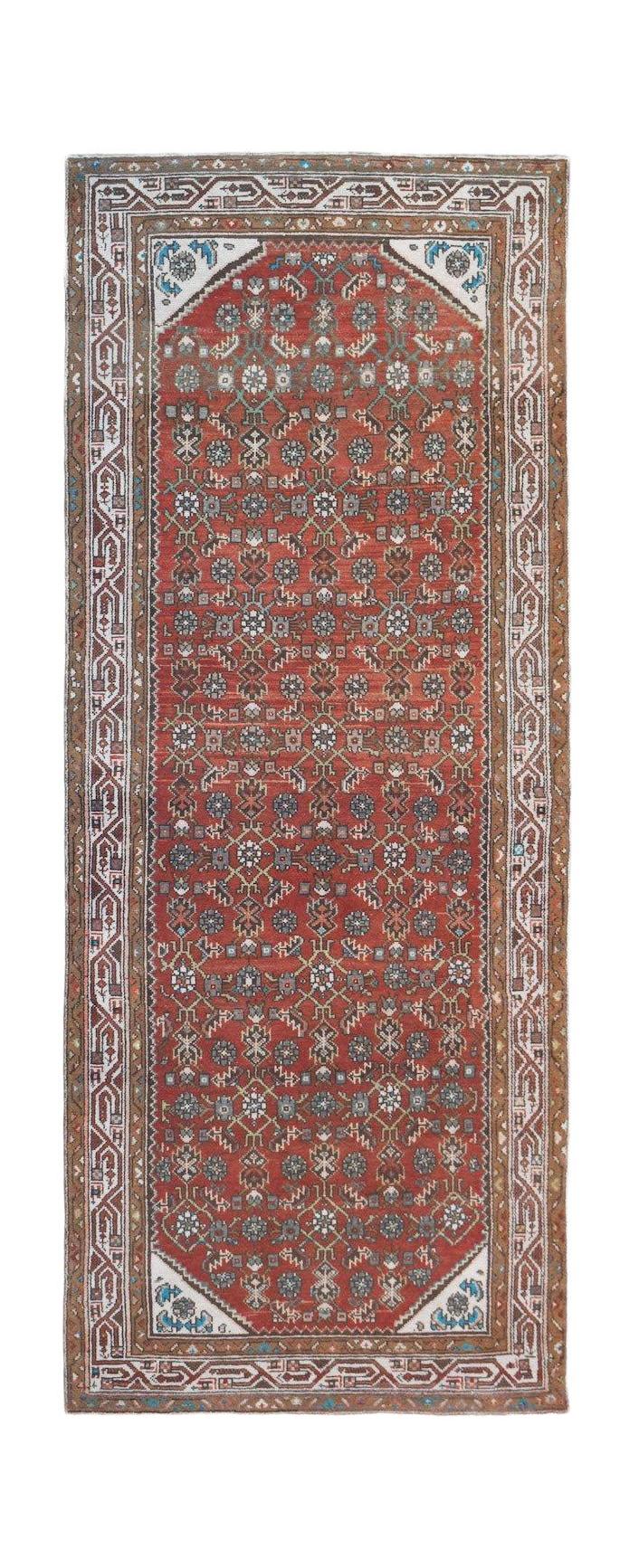 A vintage handwoven Persian Senneh runner featuring a red field with intricate geometric patterns.