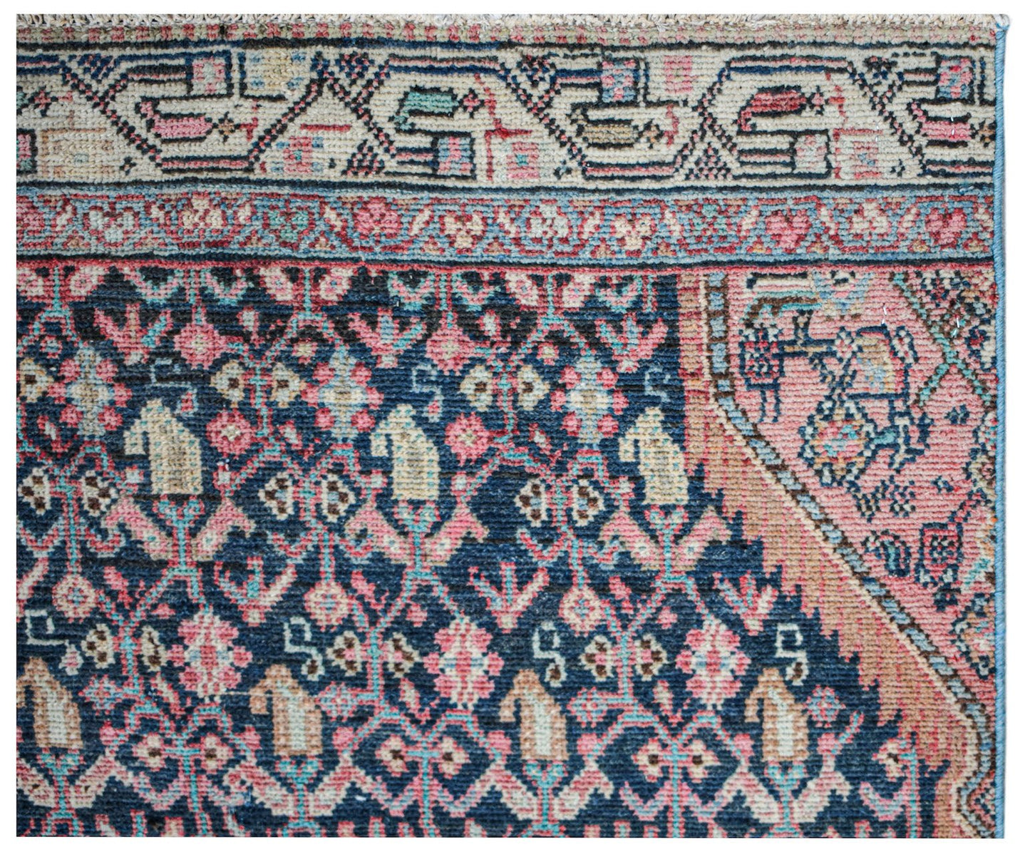 A vintage Persian Senneh runner featuring a dark blue field with intricate floral and geometric motifs.