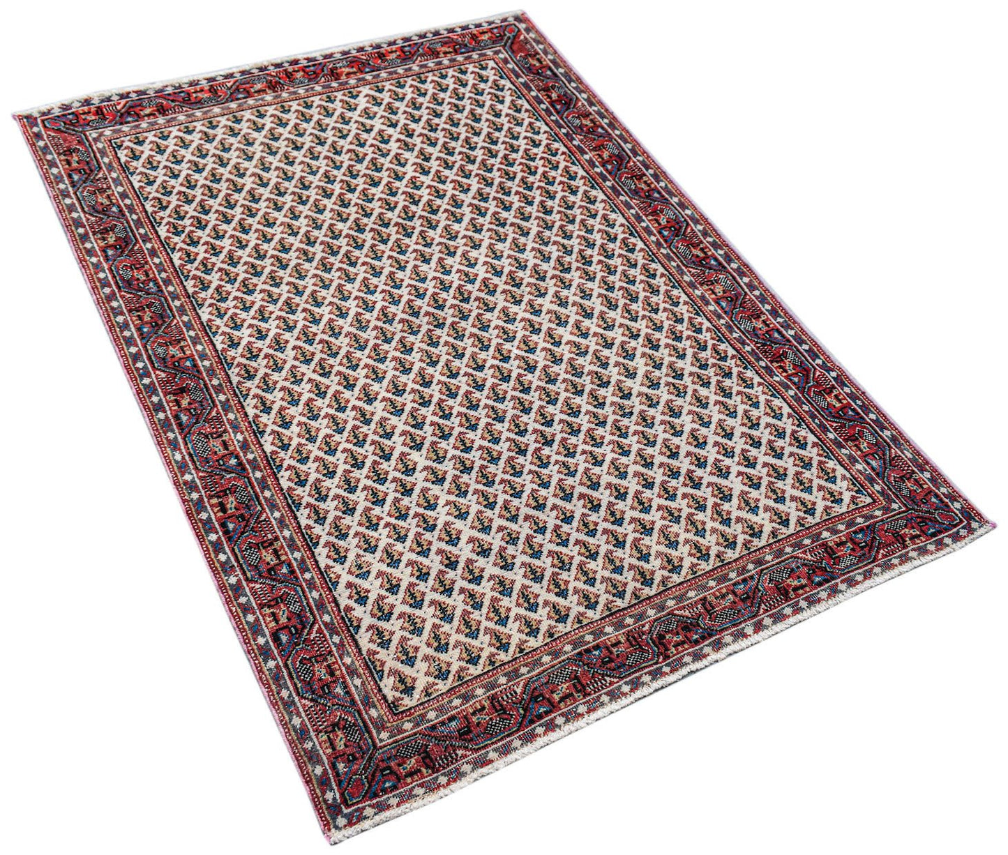 A vintage handwoven Persian Saraband rug featuring a repeating geometric pattern in red and blue.