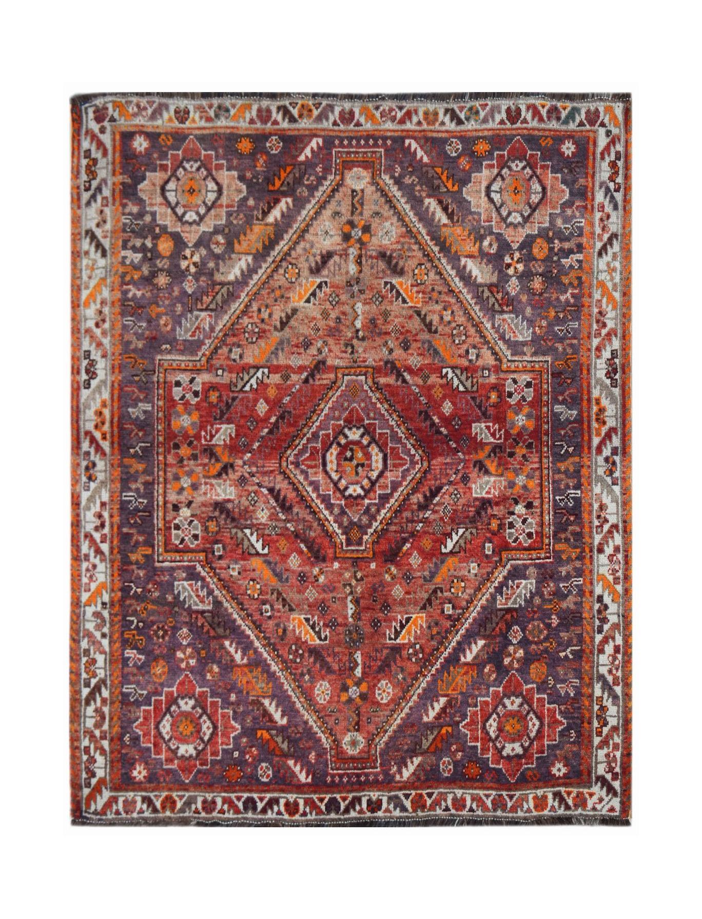 A vintage handwoven Persian Shiraz rug featuring a geometric diamond pattern in red and purple.