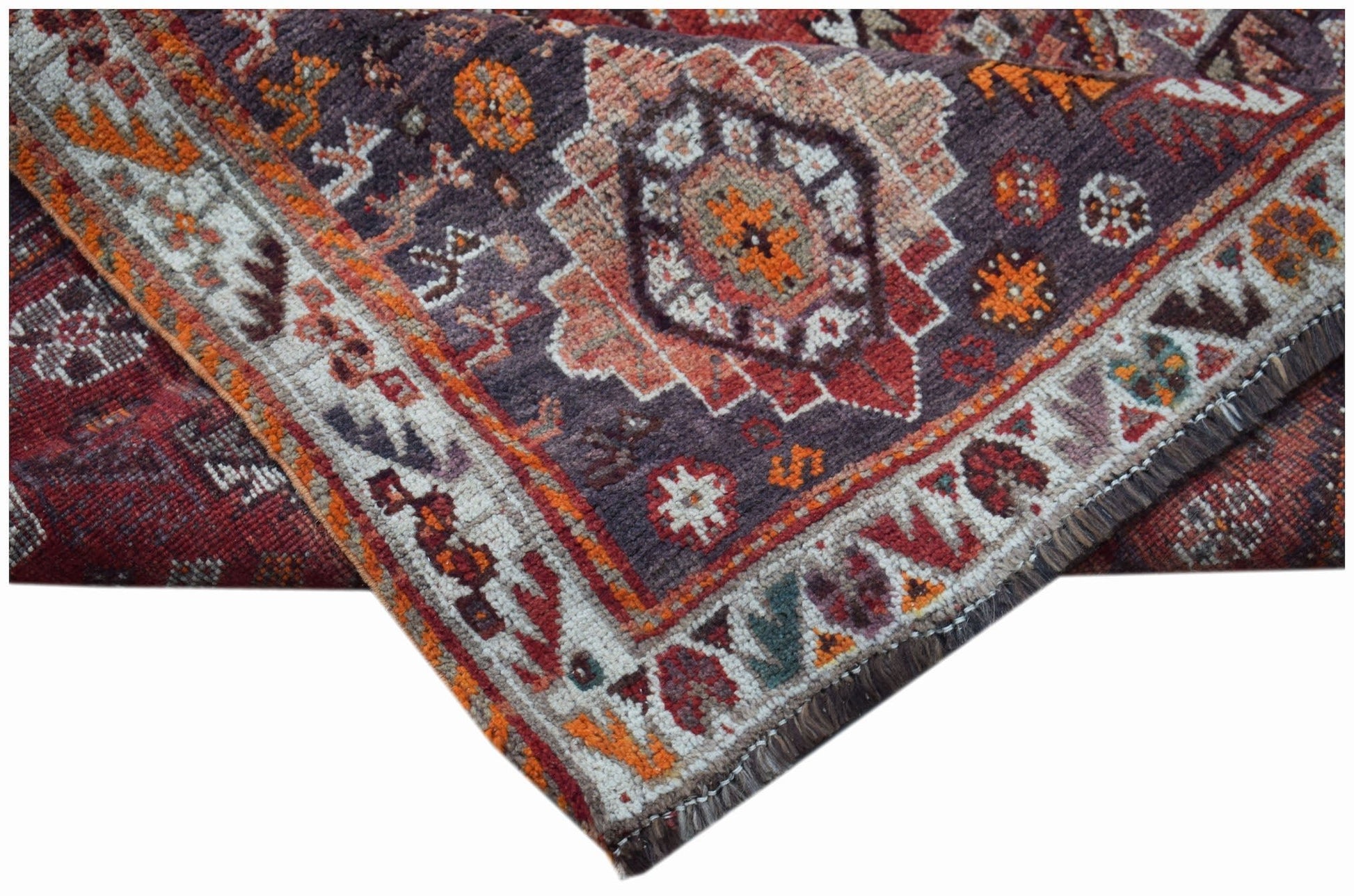 A handwoven vintage Persian Shiraz rug featuring a geometric medallion pattern in wool.