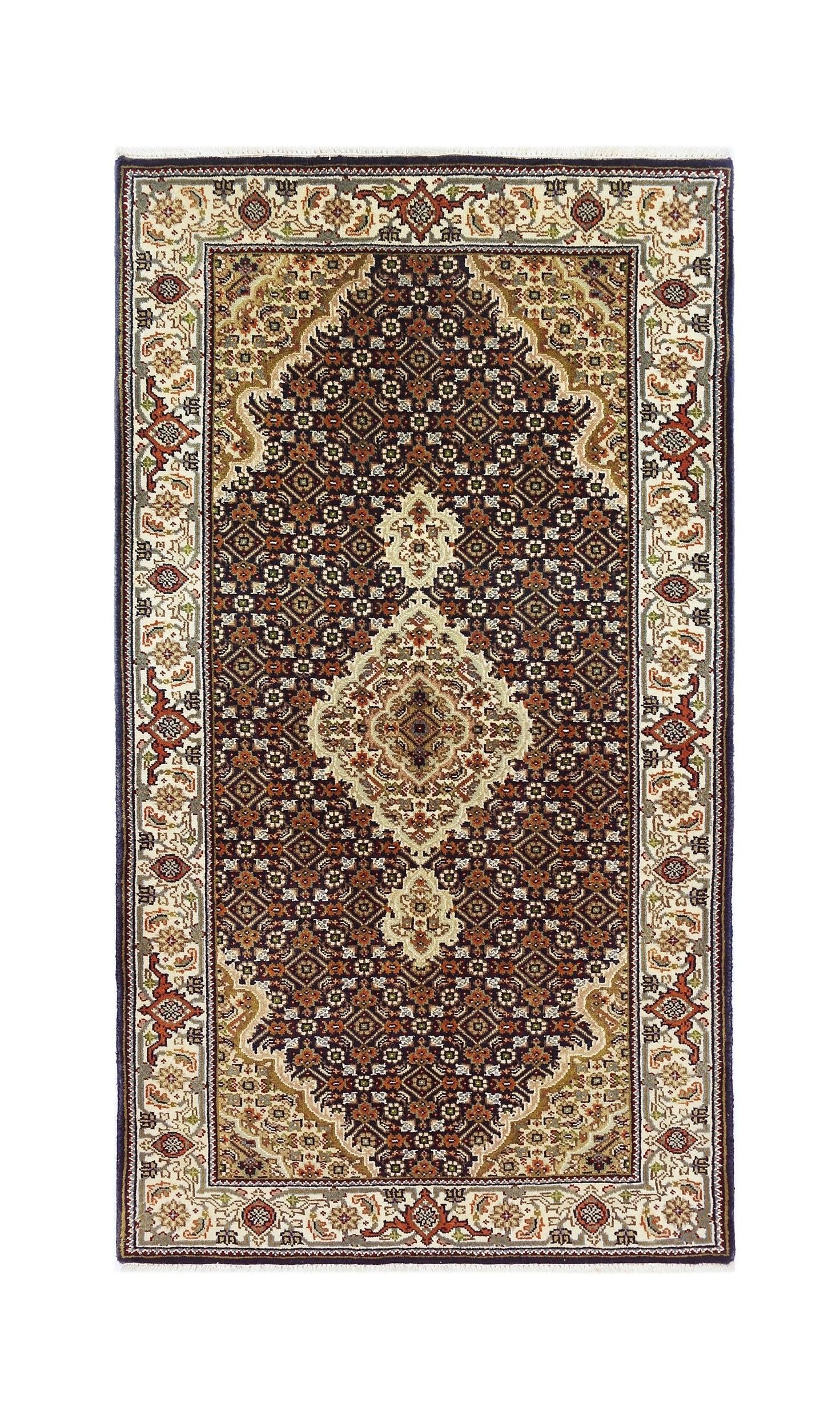 A vintage Persian silk Tabriz rug featuring an intricate floral medallion pattern in dark tones.