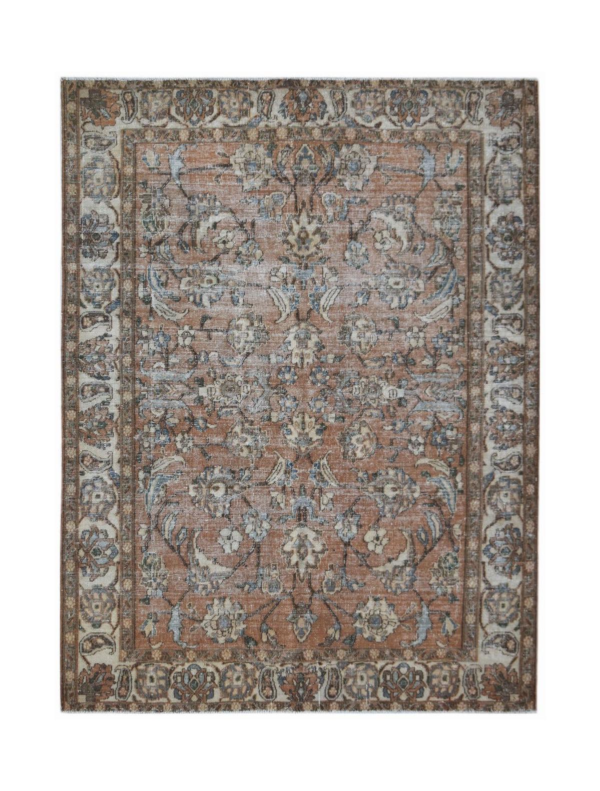 A vintage Persian Tabriz rug featuring a floral pattern in muted orange, blue, and cream tones.