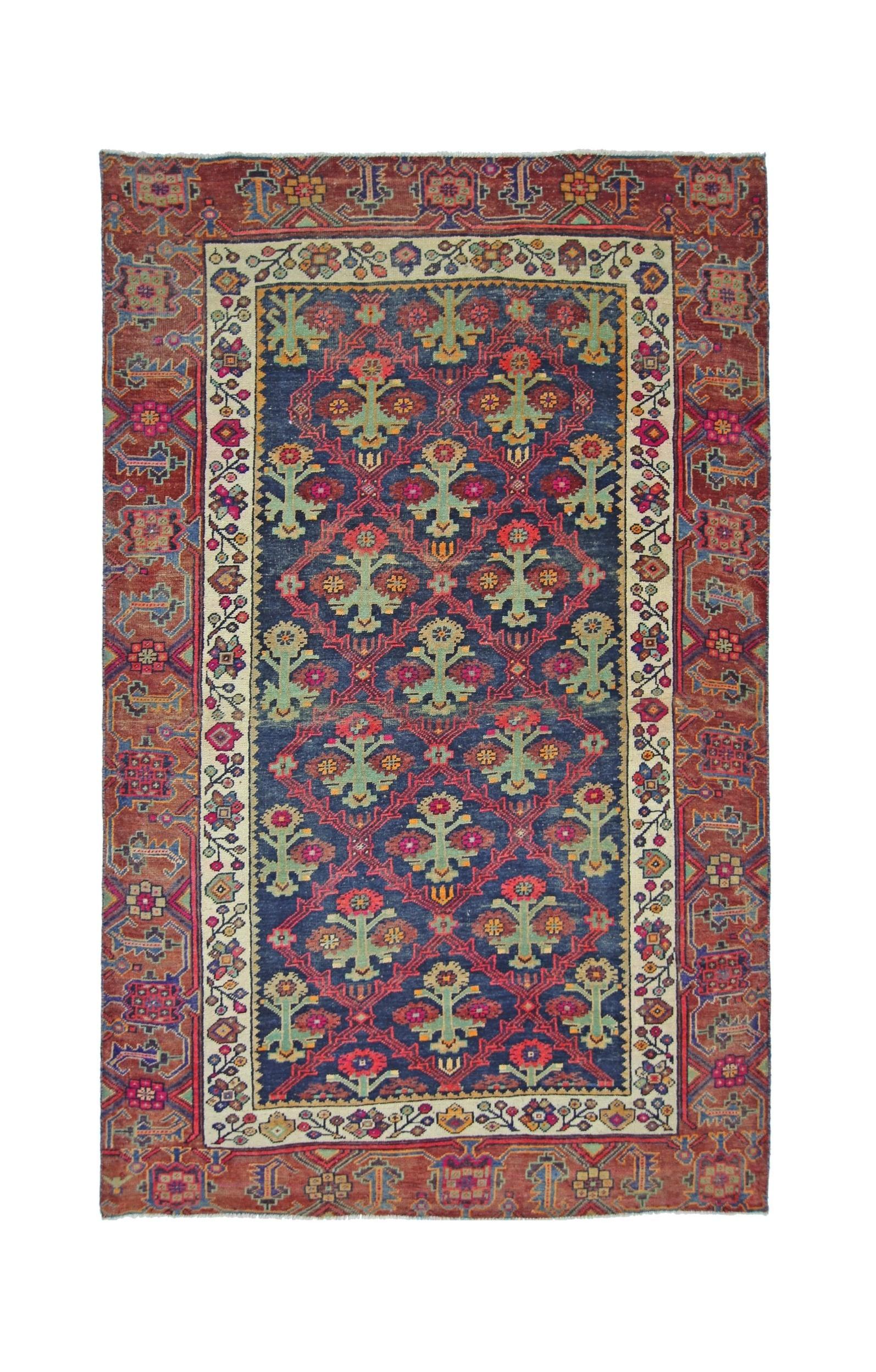 A vintage Persian Tabriz rug featuring a blue field with floral motifs and a red border.