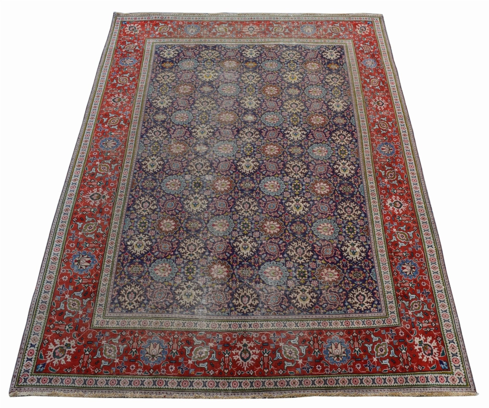A vintage handwoven Persian Tabriz rug featuring a dark blue field with intricate floral patterns.