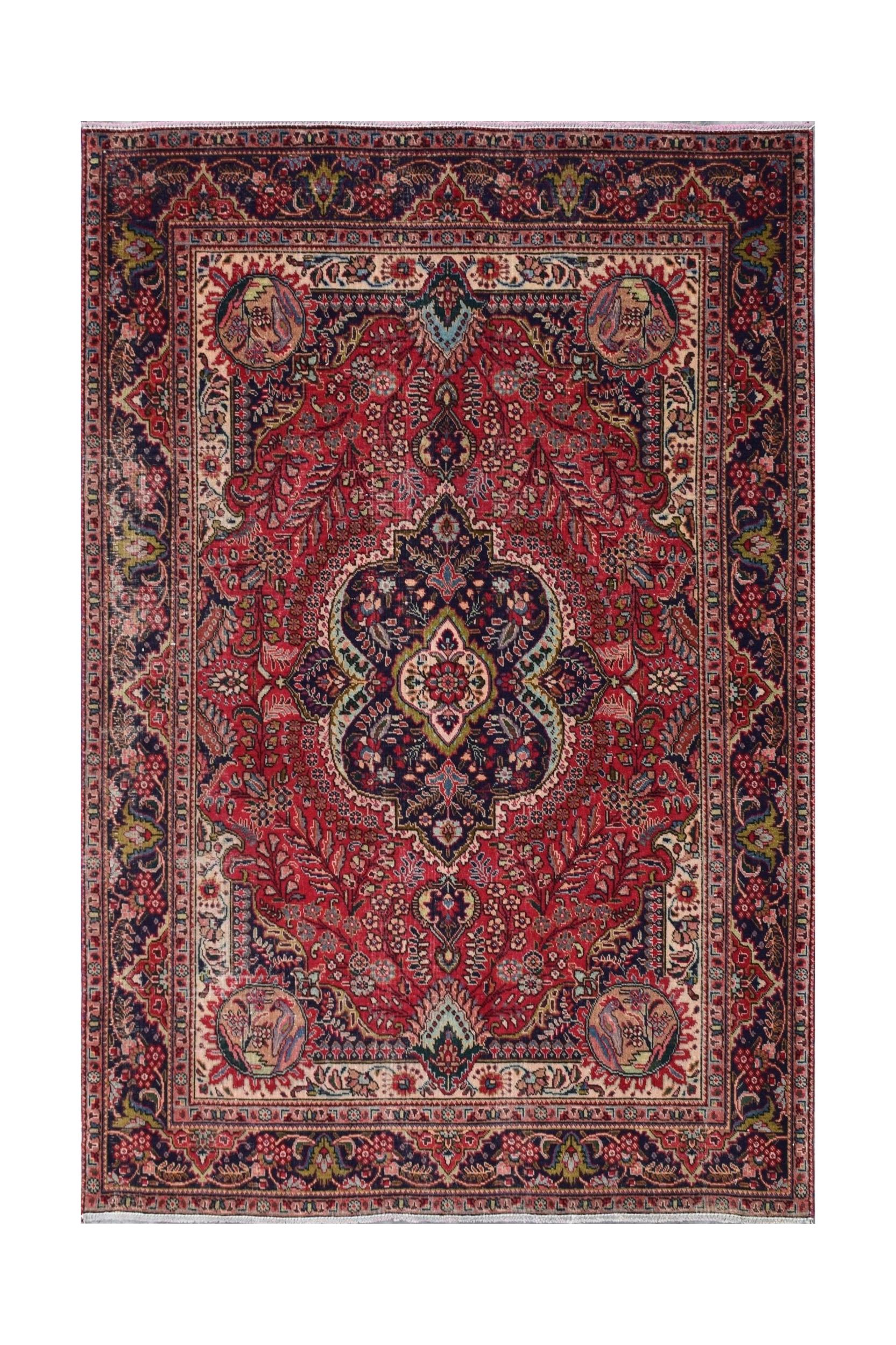 A vintage Persian Tabriz rug featuring a central medallion and intricate floral patterns in red.