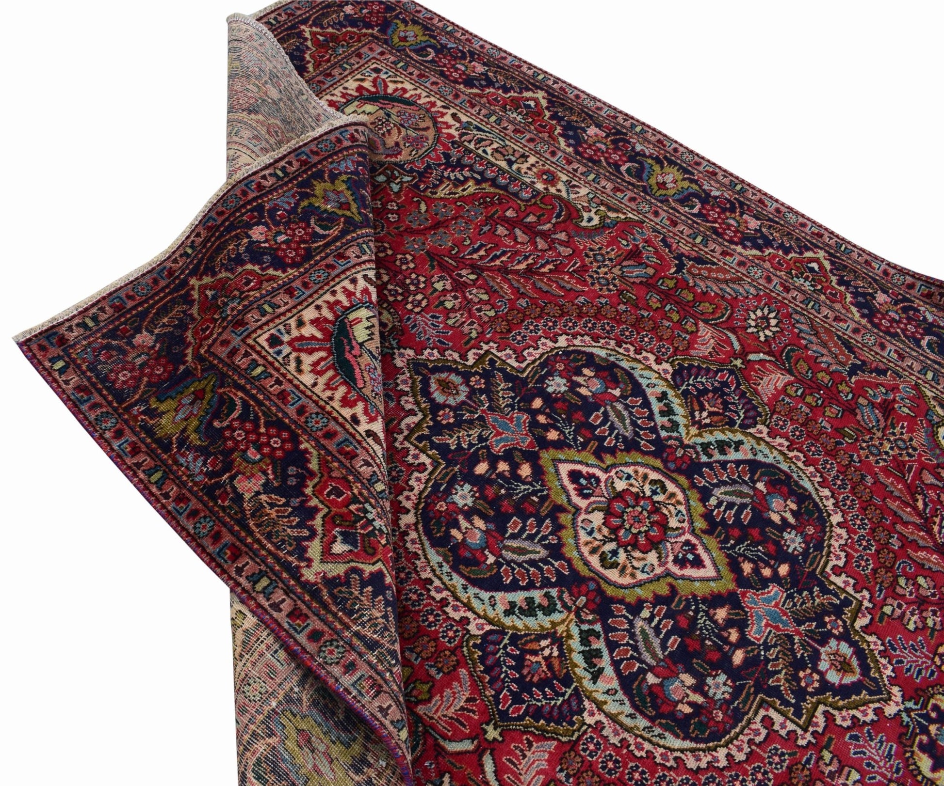 A vintage Persian Tabriz rug featuring a central medallion and intricate floral patterns in red.