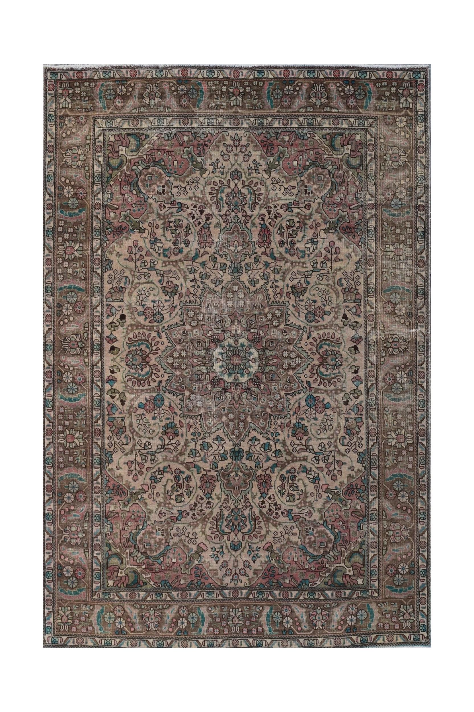 A vintage handwoven Persian Tabriz rug featuring intricate floral patterns in muted earth tones.