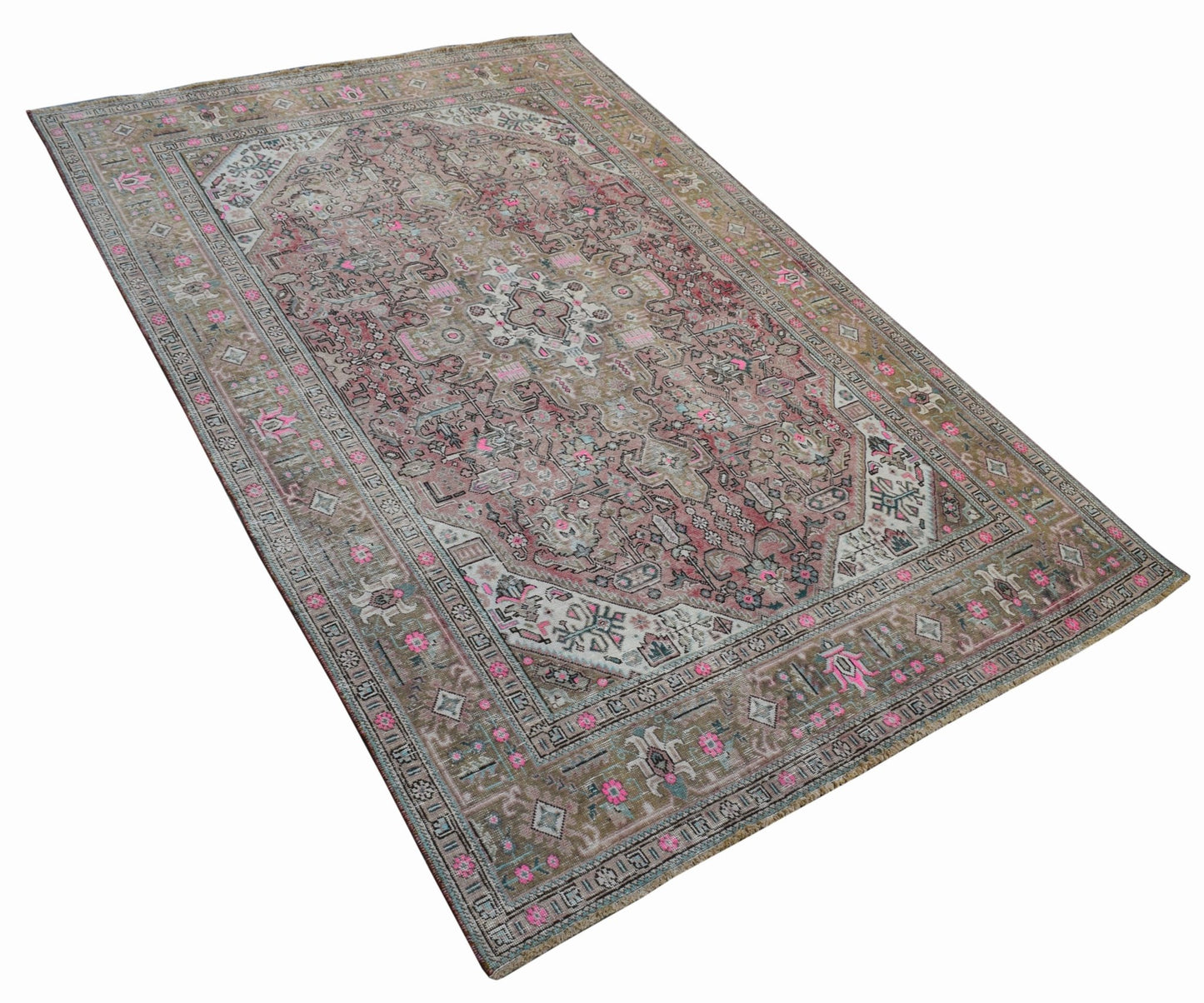 A vintage handwoven Persian Tabriz rug featuring intricate floral patterns in pink and muted tones.