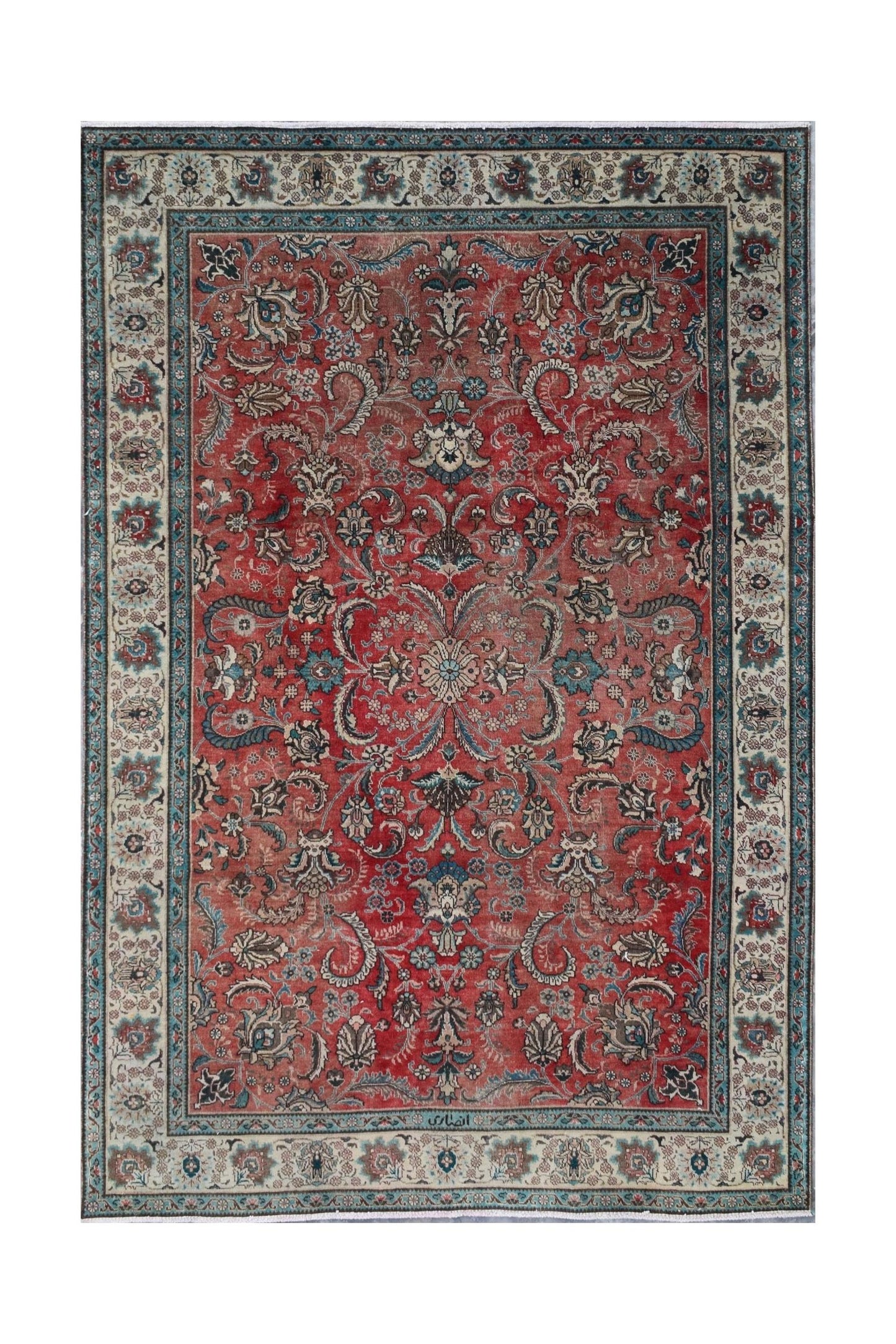 A vintage Persian Tabriz rug featuring an intricate floral medallion design on a red field.